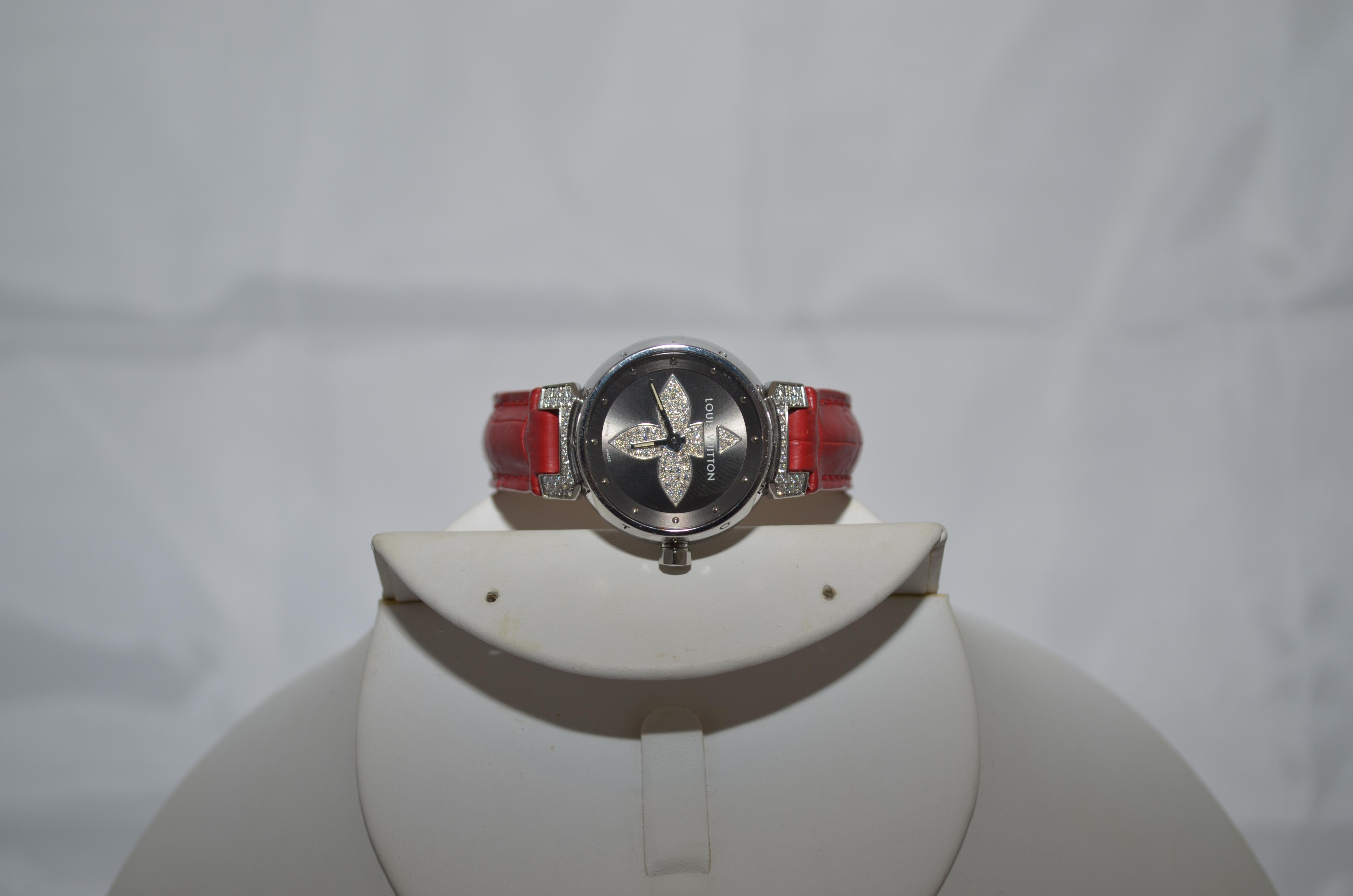 Louis Vuitton watch features a red genuine alligator band with silver hardware and diamonds encrusted in the face. Watch length measures approximately 8 inches. Excellent condition.