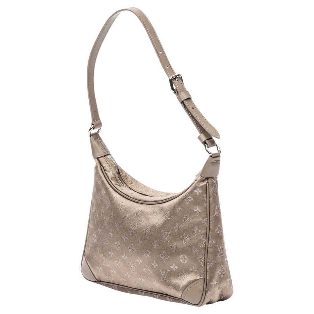 A taupe satin bag with silver hardware and zipper closure, complemented by a satin-lined interior, a delicate choice for evening wear.

SPECIFICS
Length: 7.9
Width: 2
Height: 5.9
Strap drop: 8
Authenticity code: SR0051 (May 2001)
Comes with: SDC