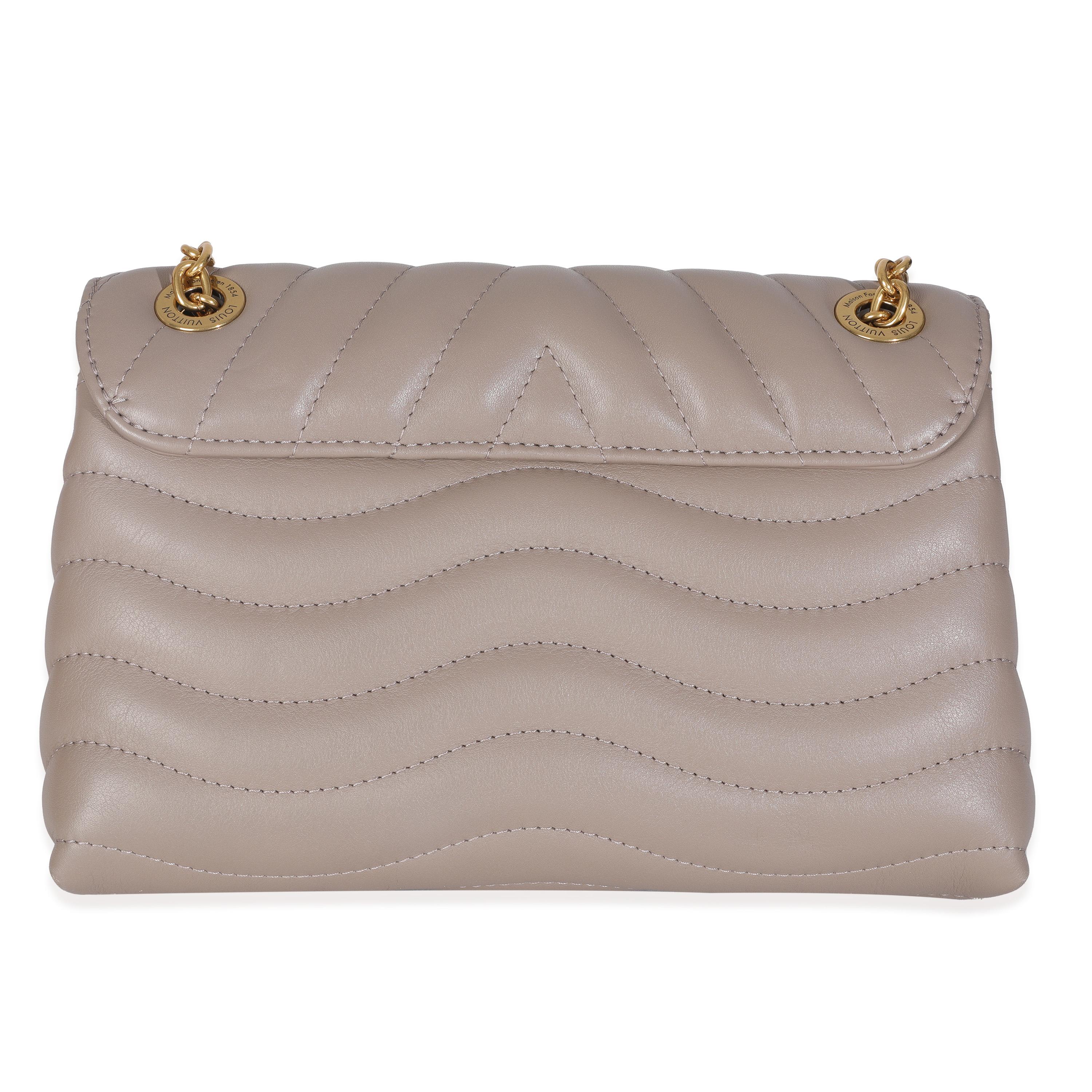 Listing Title: Louis Vuitton Taupe Calf Leather New Wave Chain MM
SKU: Z146930
Condition: Pre-owned 
Condition Description: Make waves in the style department with the New Wave bag from Louis Vuitton. A chunky logo adorns the front, while curved