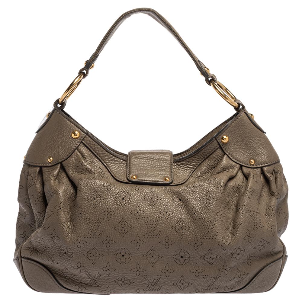 This stylish bag by Louis Vuitton will make all your handbag dream come true! This Solar PM bag has been crafted from Monogram Mahina leather and comes in a stunning shade of taupe. It has a single handle, a strap closure with a gold-tone push-lock.