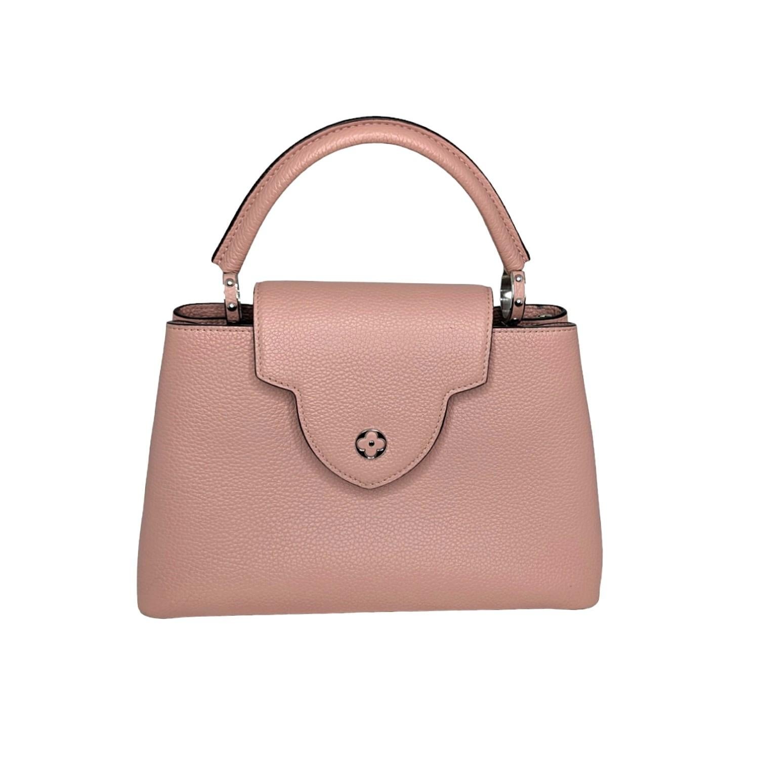 This Louis Vuitton Taurillion Capucines MM was made in France and it is finely crafted of Louis Vuitton Taurillion Leather with silver-tone hardware features. It has single rolled leather top handle and it also comes with a removable and adjustable