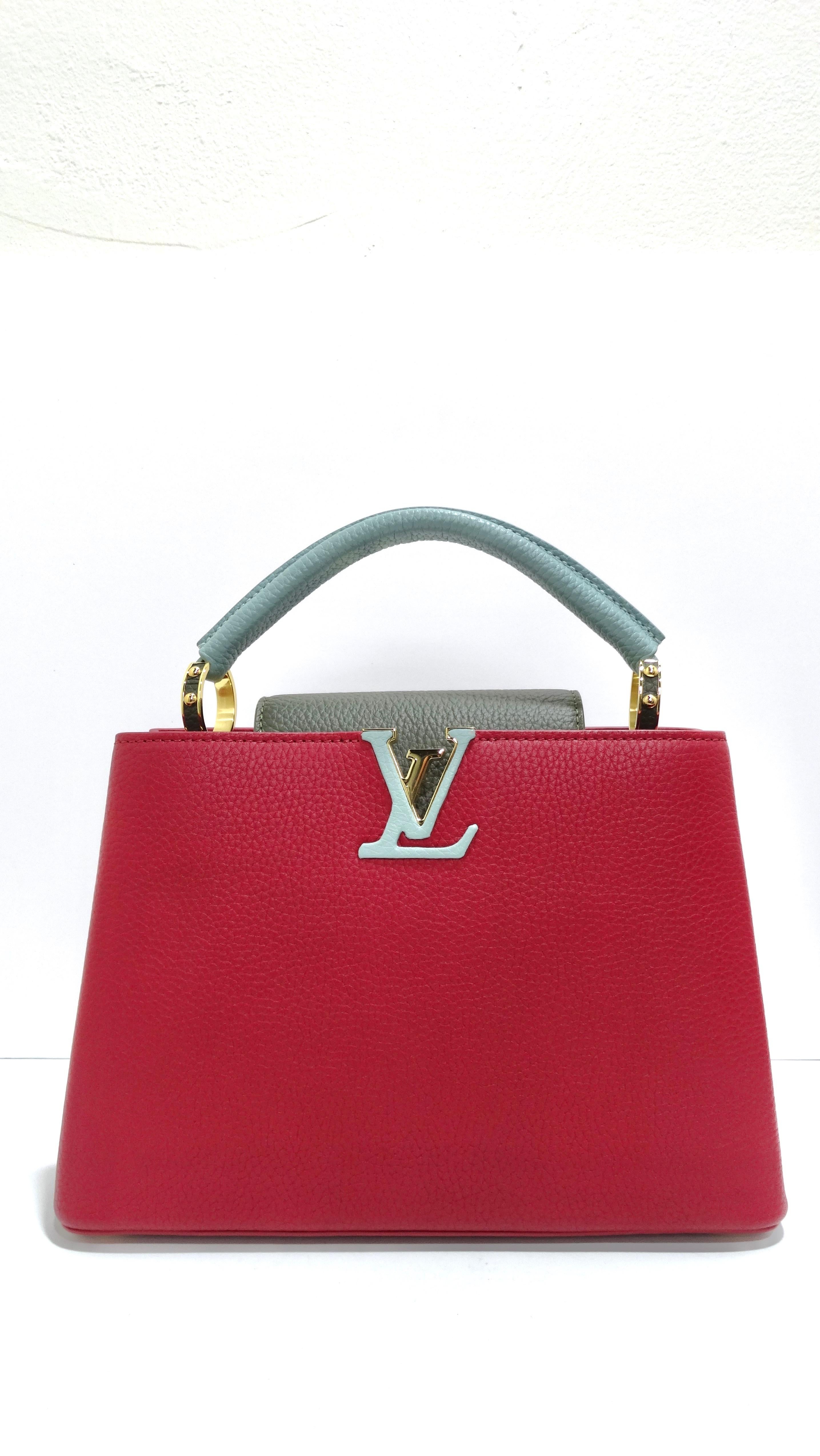 Add a pop of color to any outfit! This beautiful bag is composed of luxurious textured calfskin leather in a deep berry burgundy pink accompanied by mint and grey. The handbag features a single rolled leather reinforced top handle with stylized gold