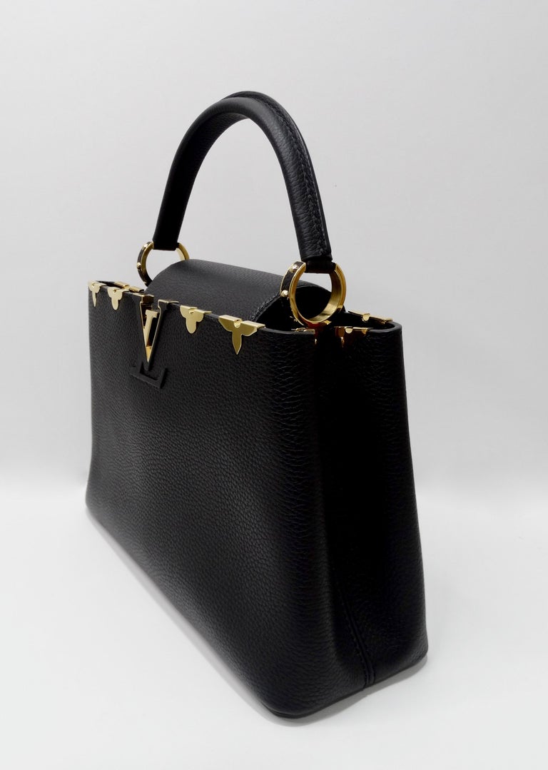Add this limited edition beauty to your collection! Circa 2019 but originally introduced in 2013, this particular bag is named from the Rue des Capucines in Paris, where Louis Vuitton opened for business in 1854. Crafted from full-grain matte black