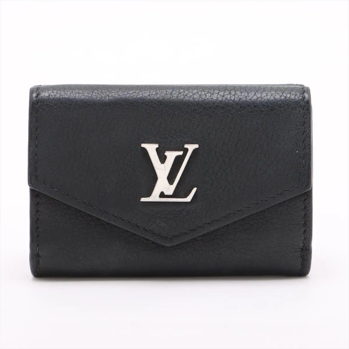 The Louis Vuitton Taurillon Lockmini Wallet in Noir is a compact yet elegant accessory that combines luxury with everyday functionality. Crafted from supple Taurillon leather in a timeless black hue, it features a refined grain texture that enhances