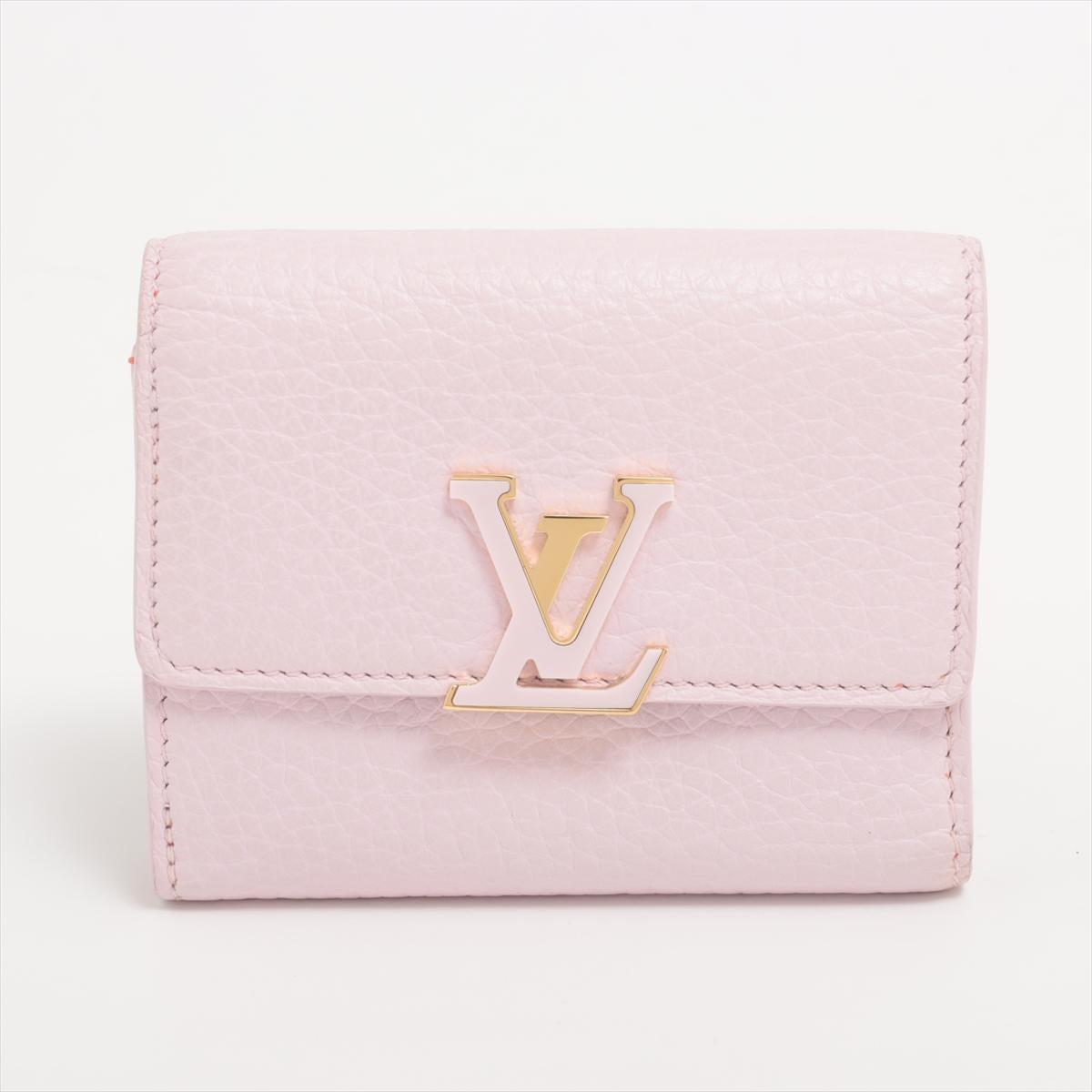 The Louis Vuitton Taurillon Portefeuille Capucine XS in Lilac x Orange is a striking accessory that exudes luxury and style. Crafted from premium Taurillon leather, it boasts a supple texture and durability that speaks to Louis Vuitton's commitment