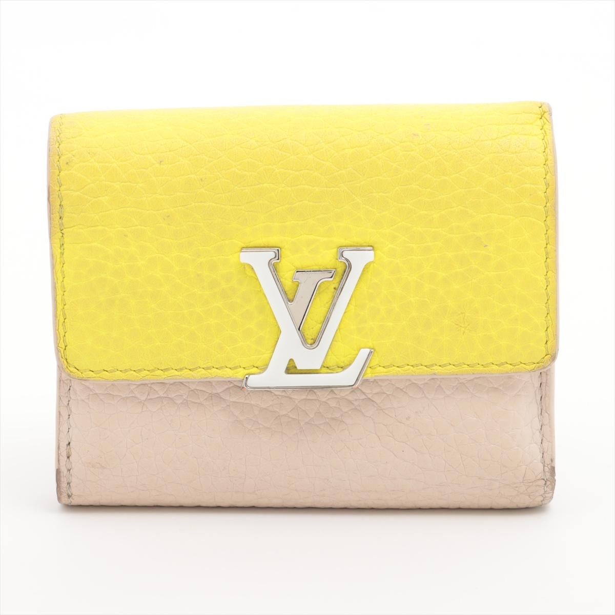The Louis Vuitton Taurillon Portefeuille Capucines in Yellow x Beige is a luxurious and sophisticated wallet that epitomizes timeless elegance. Crafted from exquisite Taurillon leather, renowned for its supple texture and durability, the wallet