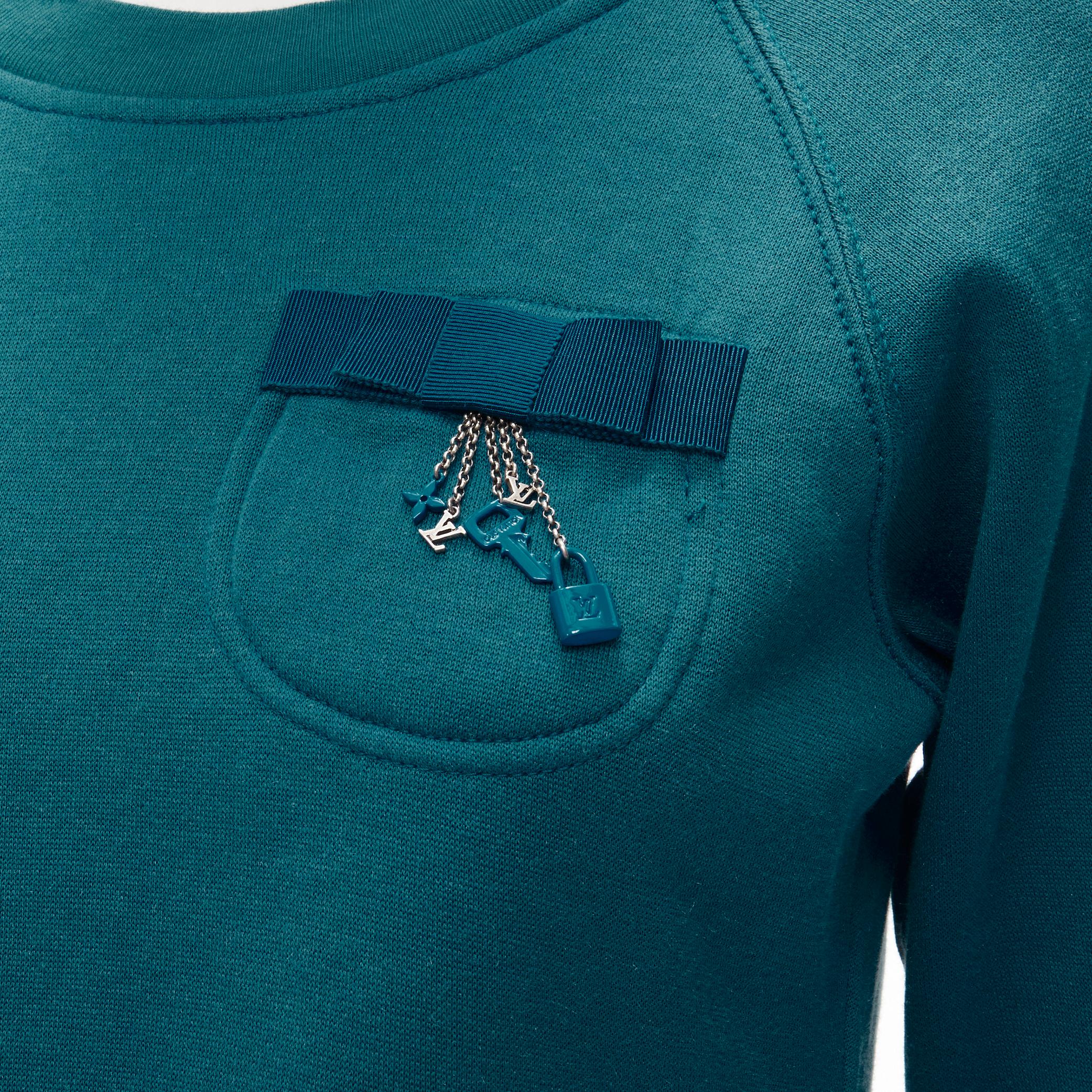 LOUIS VUITTON teal blue bow lock charm patch pocket cotton fleece sweater S 
Reference: ANWU/A00651 
Brand: Louis Vuitton 
Material: Feels like cotton 
Color: Blue 
Pattern: Solid 
Extra Detail: Patch pocket at chest with blue grosgrain bow and
