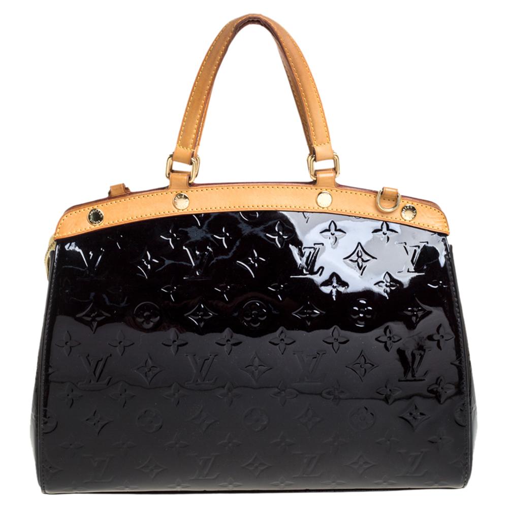 The feminine shape of Louis Vuitton's Brea is inspired by the doctor's bag. Crafted from Monogram Vernis leather in brown, the bag has a perfect finish. The fabric interior is spacious and it is secured by a zipper. The bag features double handles,