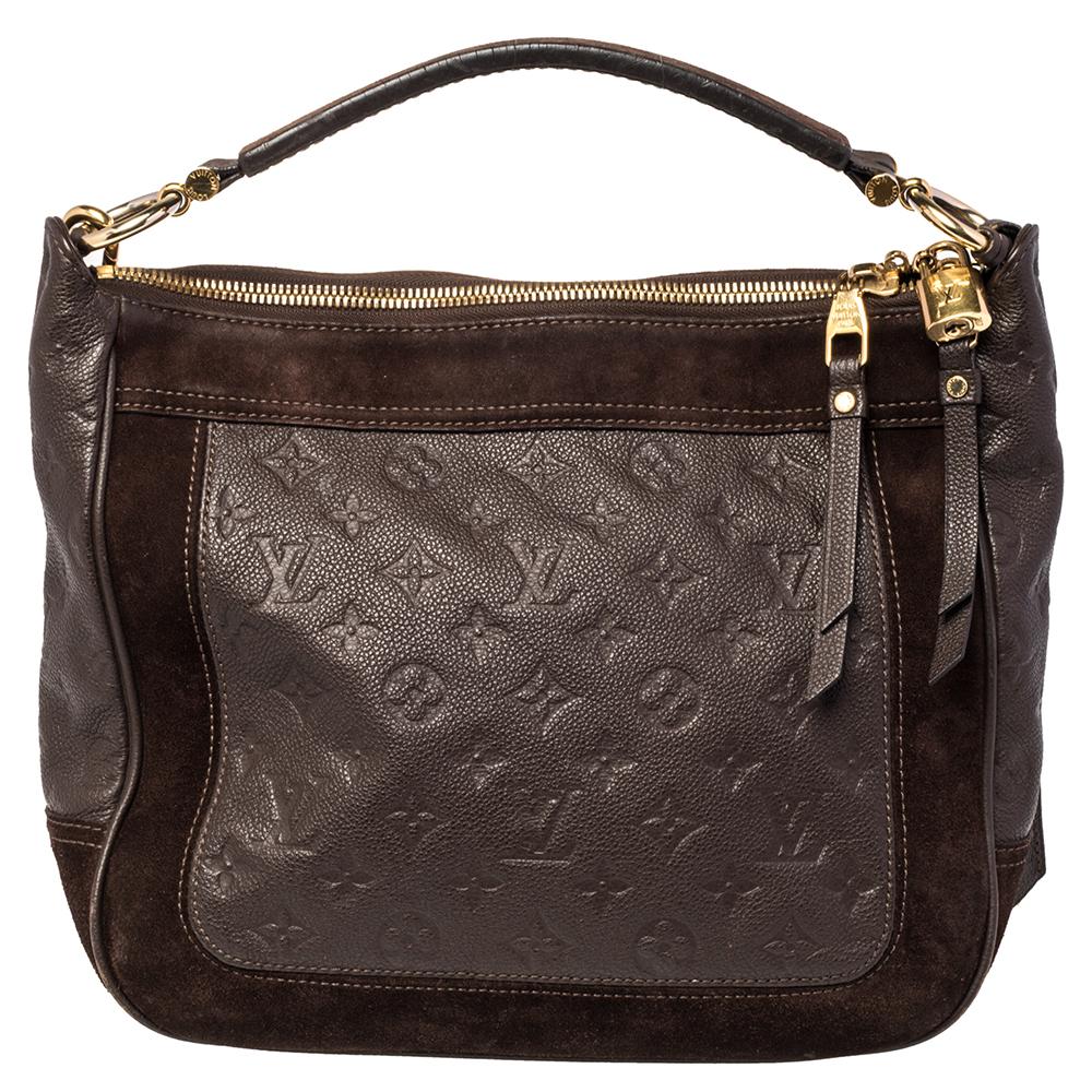 Flaunt this Louis Vuitton Audacieuse PM bag like a fashionista! Crafted from suede and monogram Empreinte leather, this bag was made in France and it features a top with double zippers that reveal a canvas-lined interior spacious enough to carry all