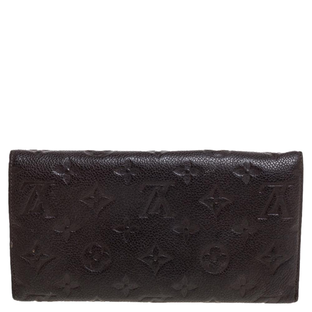 Stylish wallets are a closet must-have! This brown Virtuose wallet from Louis Vuitton is designed in a flap style and is crafted from monogram Empreinte leather. This sleek wallet comes with multiple card slots, a zip pocket, and open slots. It is
