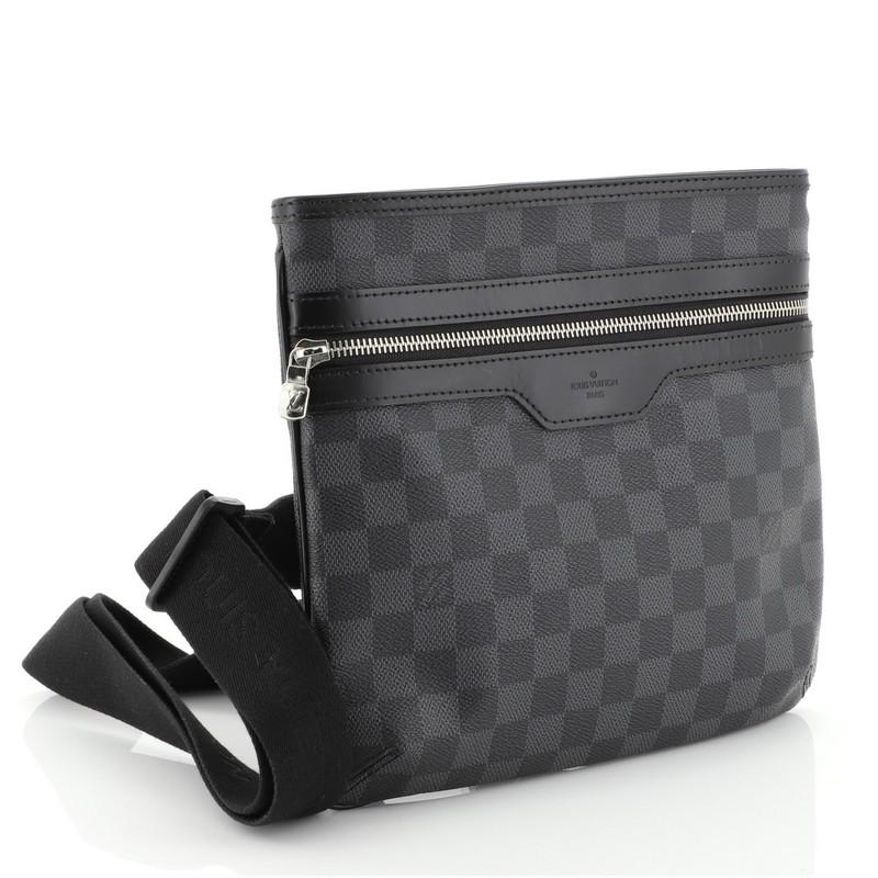 This Louis Vuitton Thomas Handbag Damier Graphite, crafted from damier graphite coated canvas, features an adjustable strap, front zip pocket and silver-tone hardware. Its top zip closure opens to a black fabric interior. Authenticity code reads: