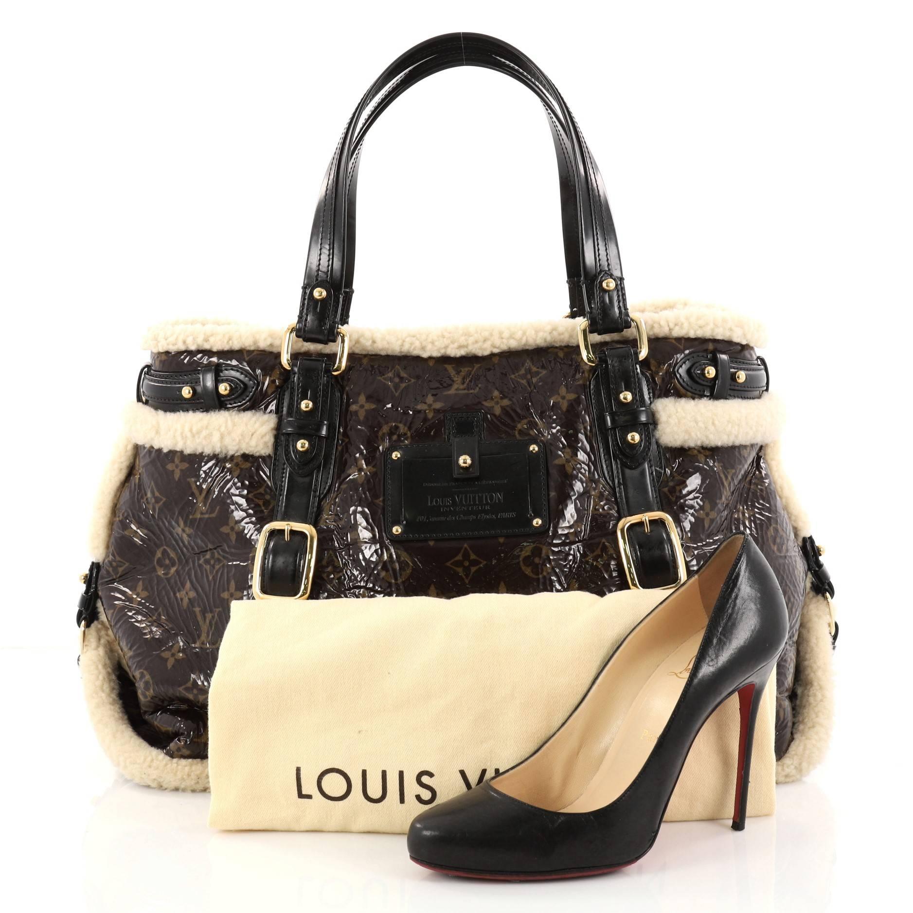 This authentic Louis Vuitton Thunder Handbag Limited Edition Monogram and Shearling is a rare limited edition runway piece. Crafted in brown monogram patent leather with off-white shearling trims, this bag features dual-flat leather handles, Louis