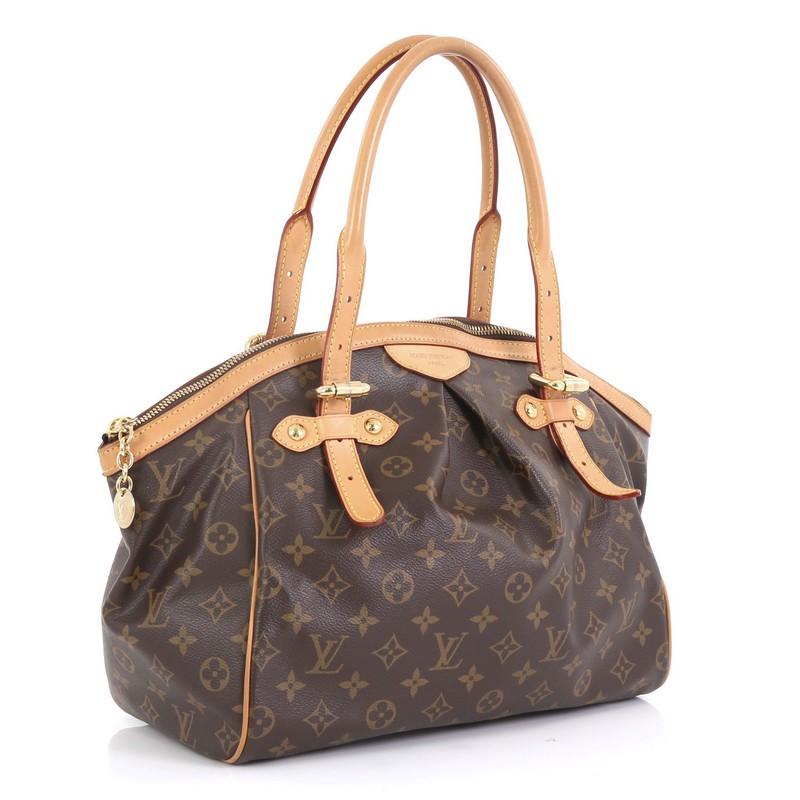 This Louis Vuitton Tivoli Handbag Monogram Canvas GM, crafted from brown monogram coated canvas, features dual rolled handles, subtle pleats in the middle, and gold-tone hardware. Its zip closure opens to a brown fabric interior with slip pockets.