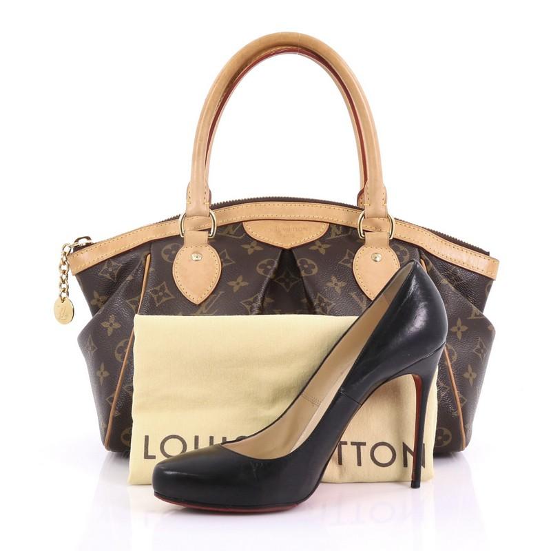 This Louis Vuitton Tivoli Handbag Monogram Canvas PM, crafted from brown monogram coated canvas, features dual rolled handles, subtle pleats in the middle, and gold-tone hardware. Its top zip closure opens to a brown fabric interior with slip