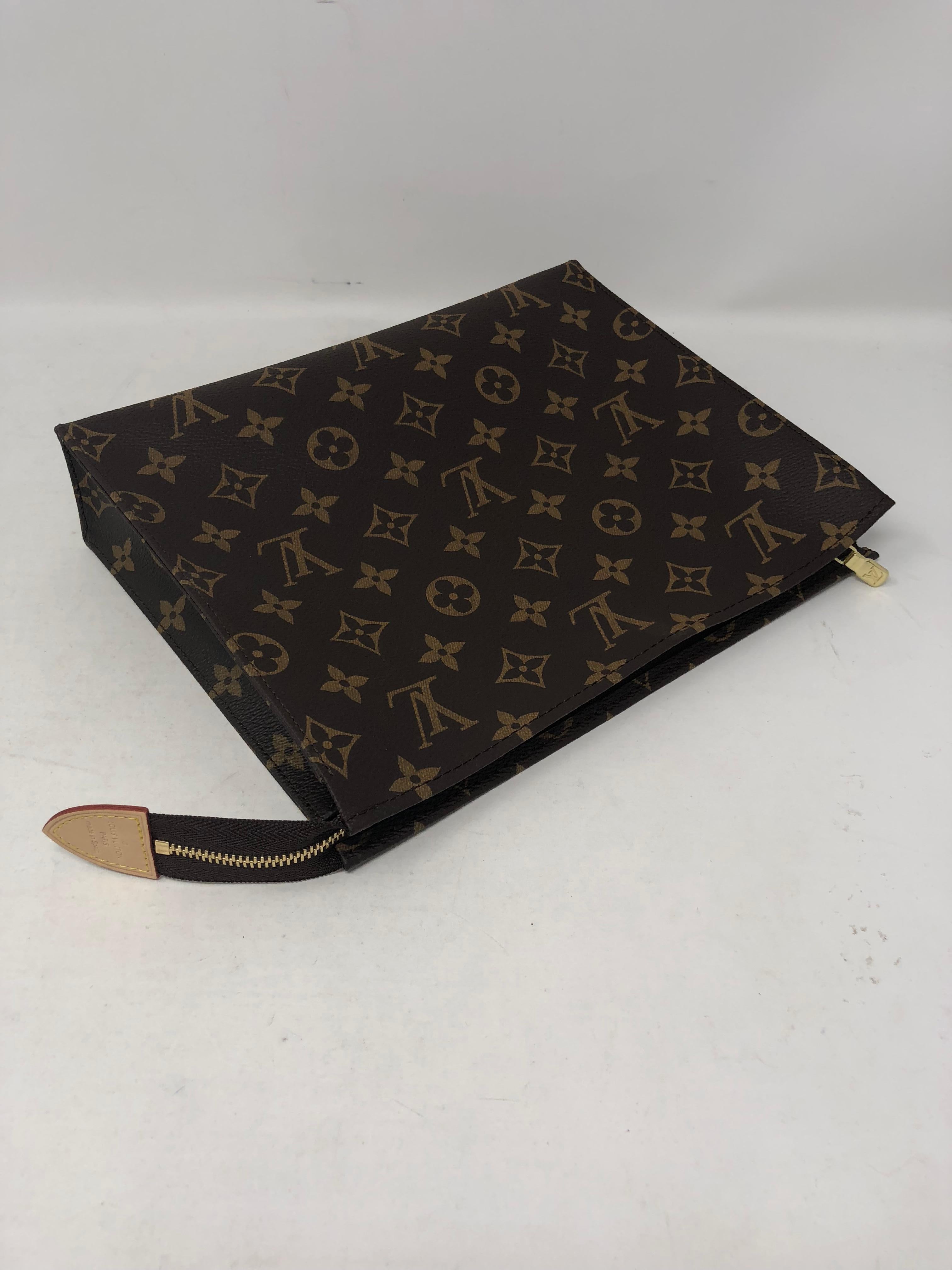 Louis Vuitton Toiletry Pouch 26 in monogram canvas. Brand new and sold out at LV. The largest size of the toiletry pouches. Makes a great clutch or insert for a large bag. The most wanted pouch. Comes with dust cover and box.  Guaranteed authentic. 