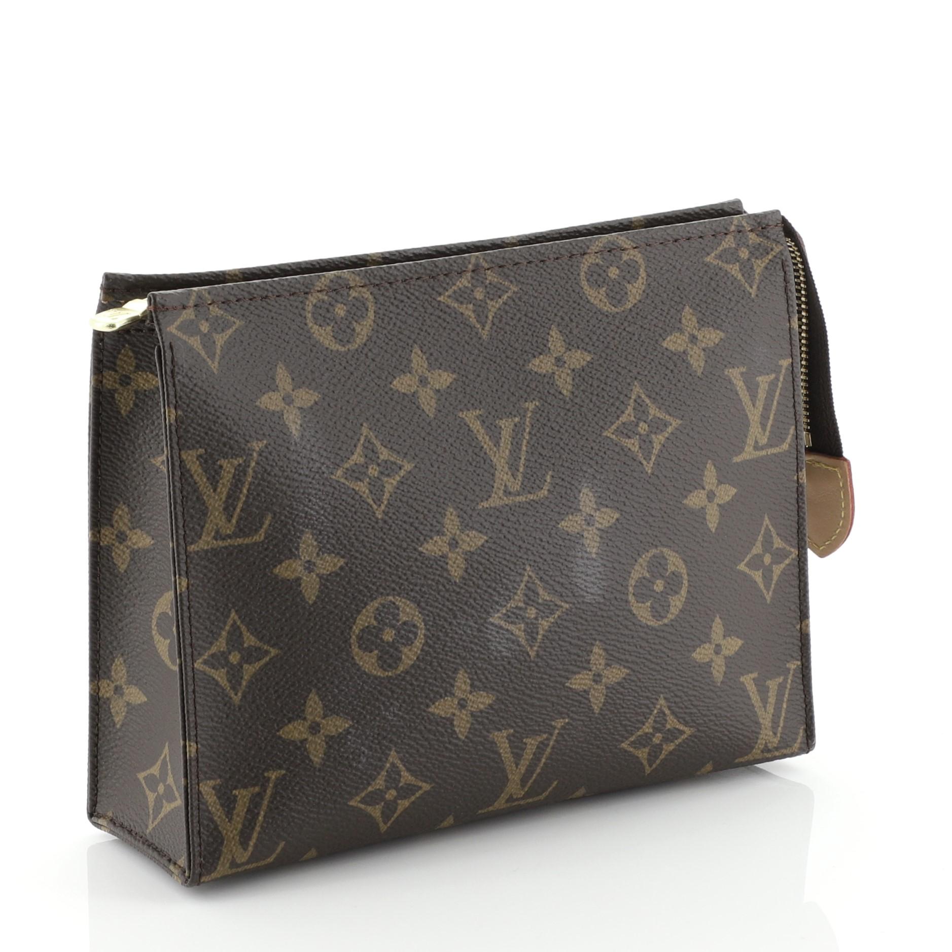 This Louis Vuitton Toiletry Pouch Monogram Canvas 19, crafted in brown monogram coated canvas, features gold-tone hardware. Its zip closure opens to a neutral leather interior. Authenticity code reads: UB1148. 

Estimated Retail Price: