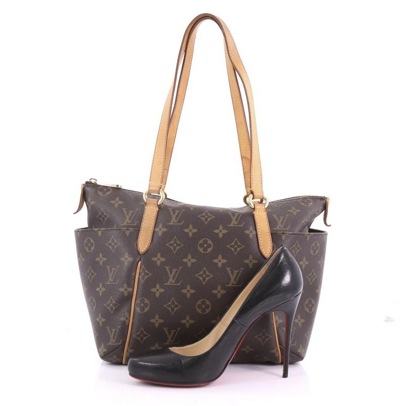 This Louis Vuitton Totally Handbag Monogram Canvas PM, crafted from brown monogram coated canvas, features tall cowhide leather handles and trims, two exterior lateral pockets, and gold-tone hardware. Its zip closure opens to a brown fabric interior