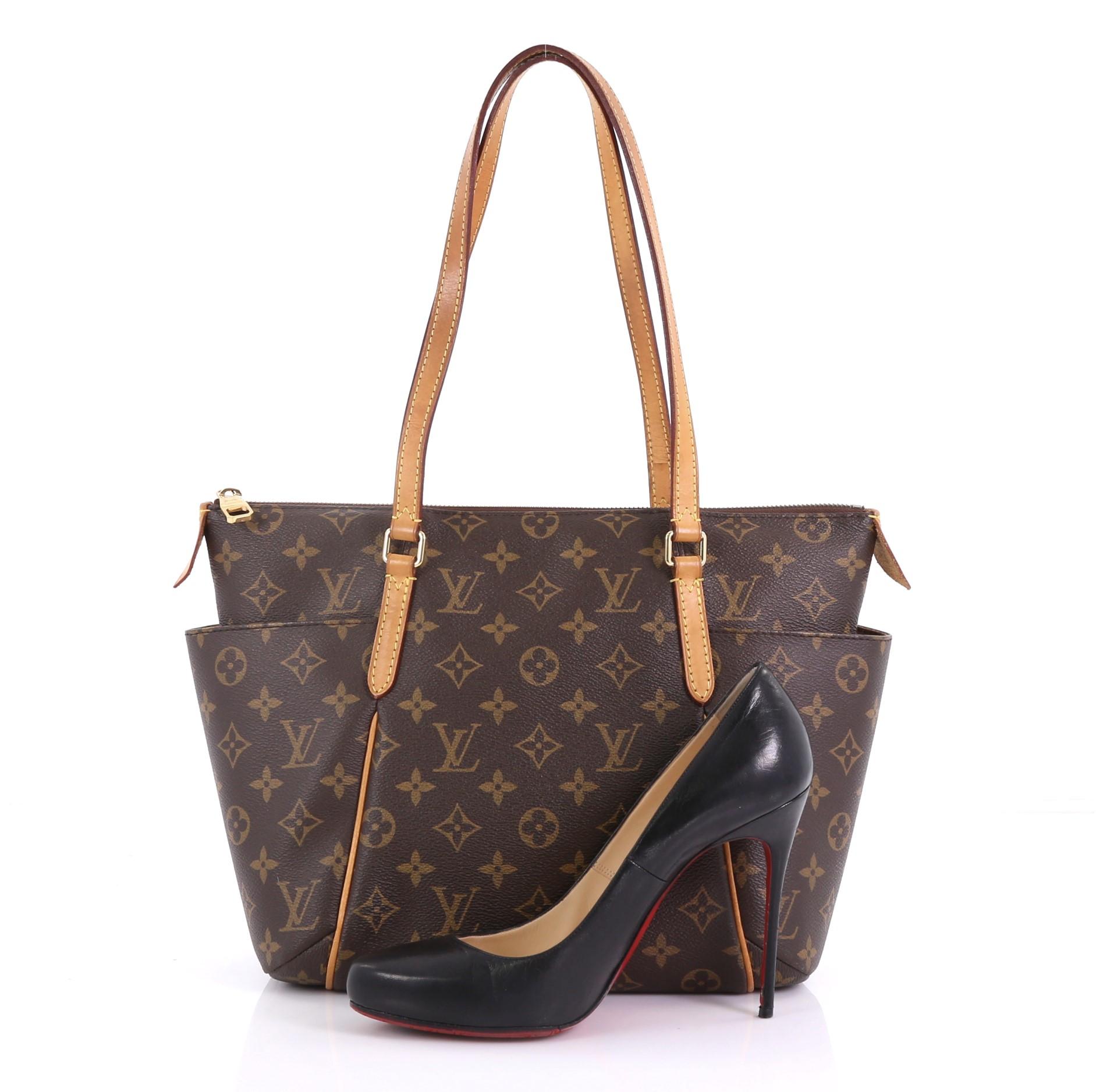 This Louis Vuitton Totally Handbag Monogram Canvas PM, crafted from brown monogram coated canvas, features tall cowhide leather handles and trim, two exterior lateral pockets, and gold-tone hardware. Its zip closure opens to a brown fabric interior