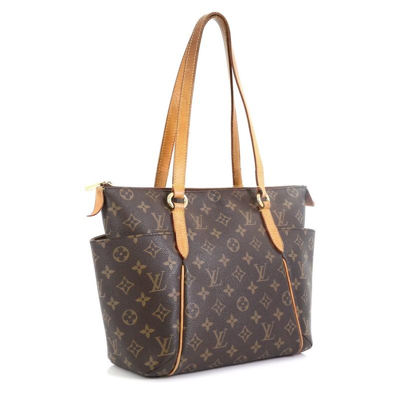 This Louis Vuitton Totally Handbag Monogram Canvas PM, crafted from brown monogram coated canvas, features tall cowhide leather handles and trim, two exterior lateral pockets, and gold-tone hardware. Its zip closure opens to a brown fabric interior