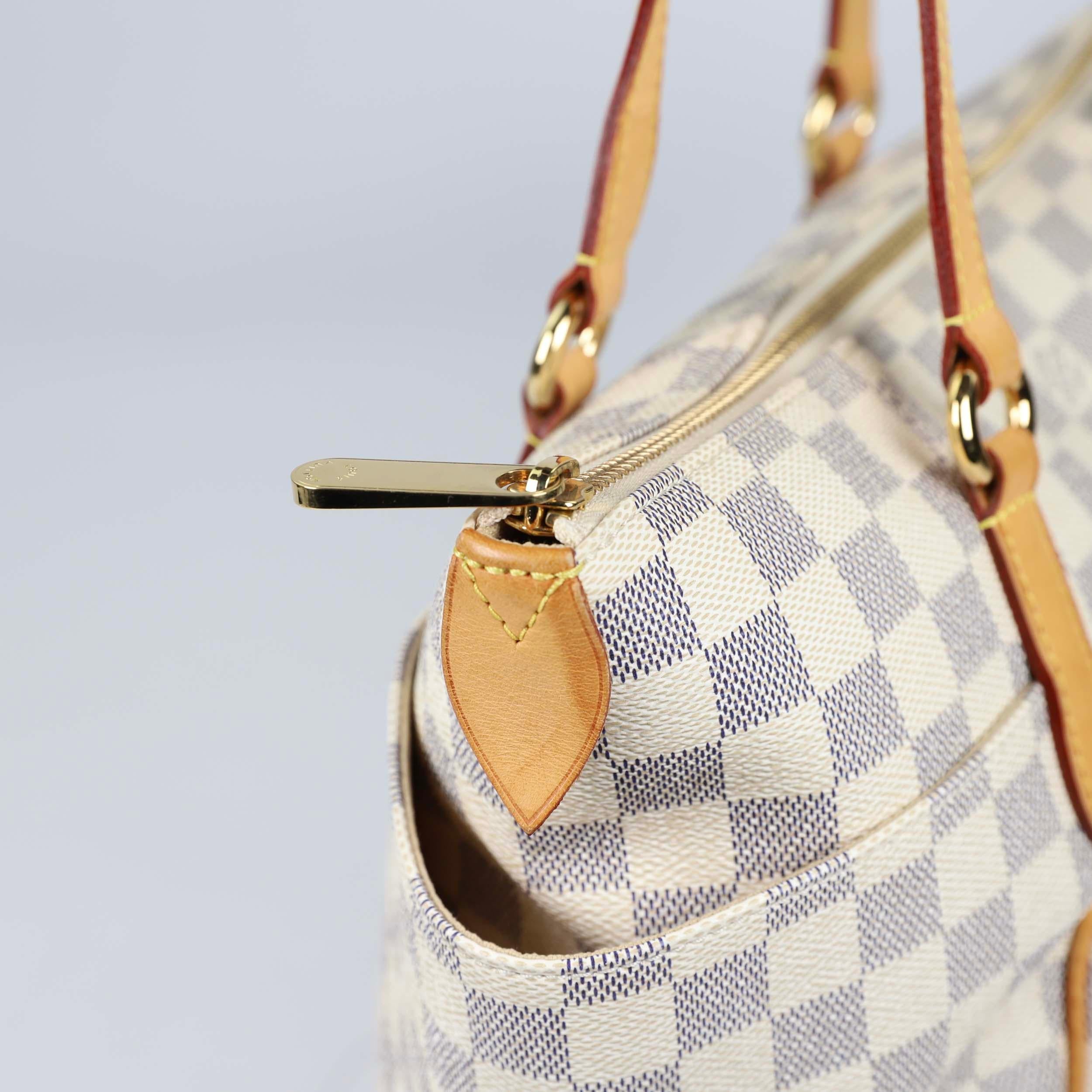 The Damier Azur Totally PM Bag is among the newest totes from Louis Vuitton and looks particularly striking in Damier Azur. It features a large yet lightweight design with an extra spacious interior and two large side pockets. This versatile tote is