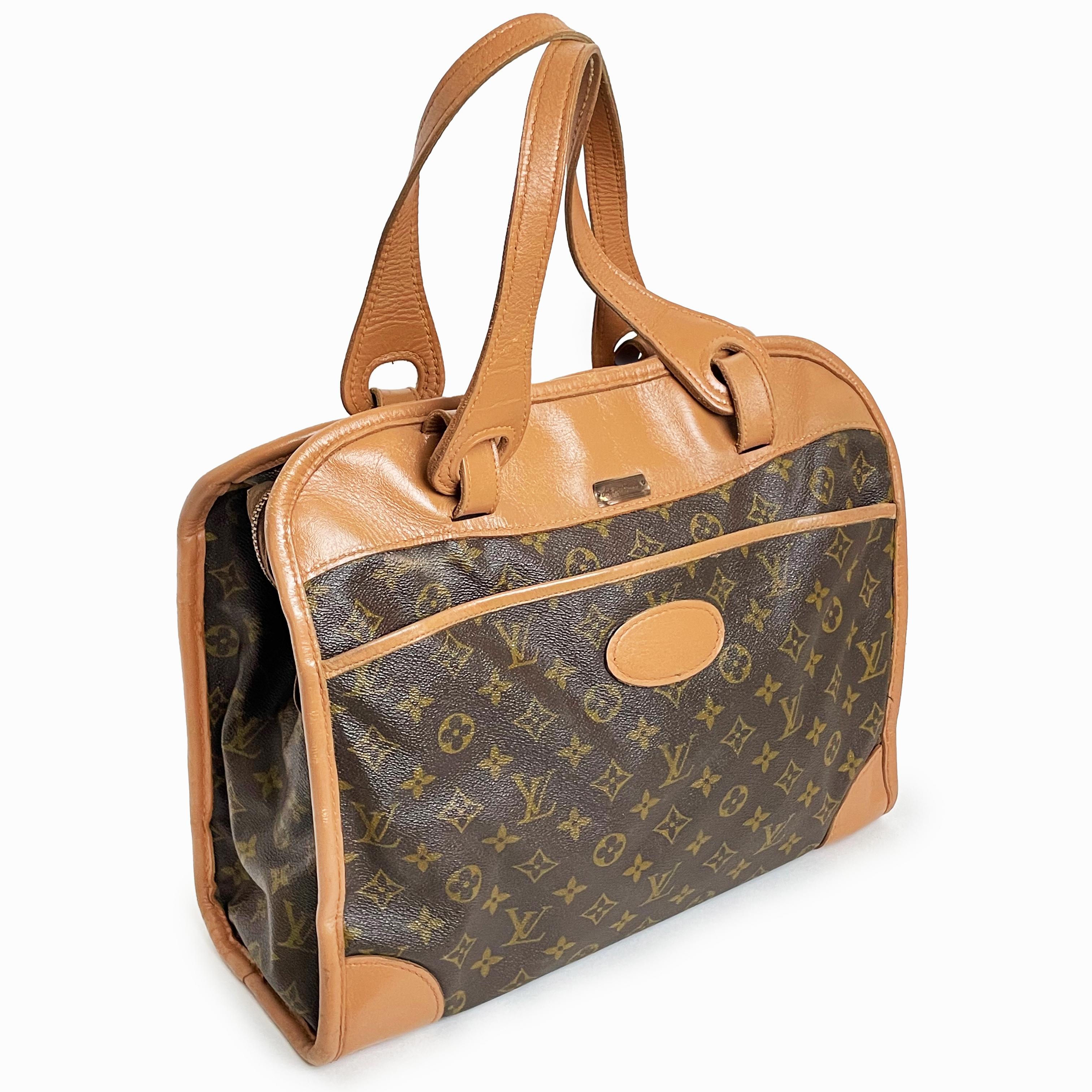 Travel in style with this authentic vintage 70s Louis Vuitton x French Luggage Co tote bag carry-on, made for Saks Fifth Avenue. It features Vuitton's classic monogram canvas and coated leather trim exterior with 1 zip exterior pocket and 1 open