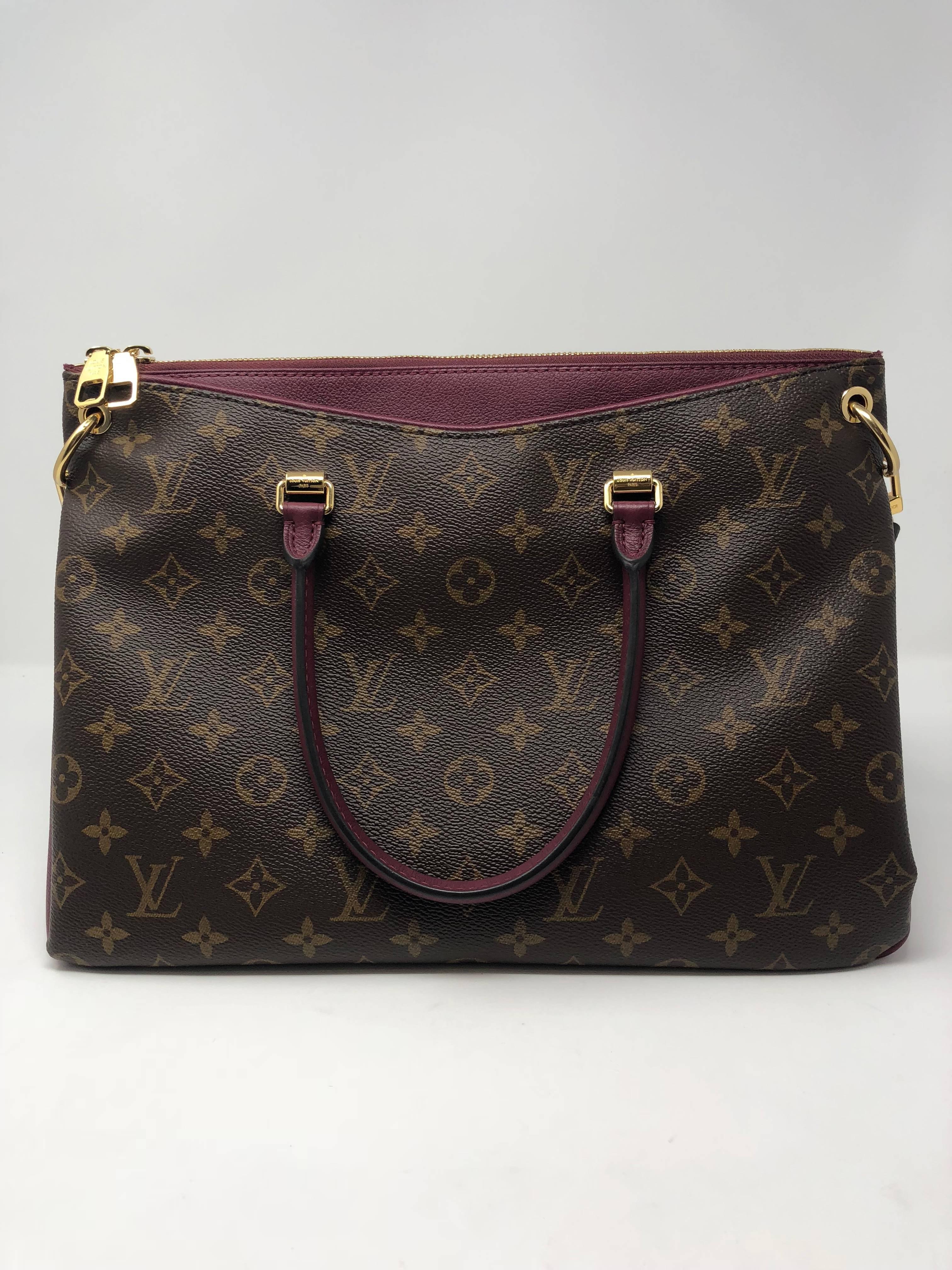 Louis Vuitton monogram and burgundy trim Pallas BB tote with additional strap. Mint condition and versatile bag can be worn two ways. Guaranteed authentic. 