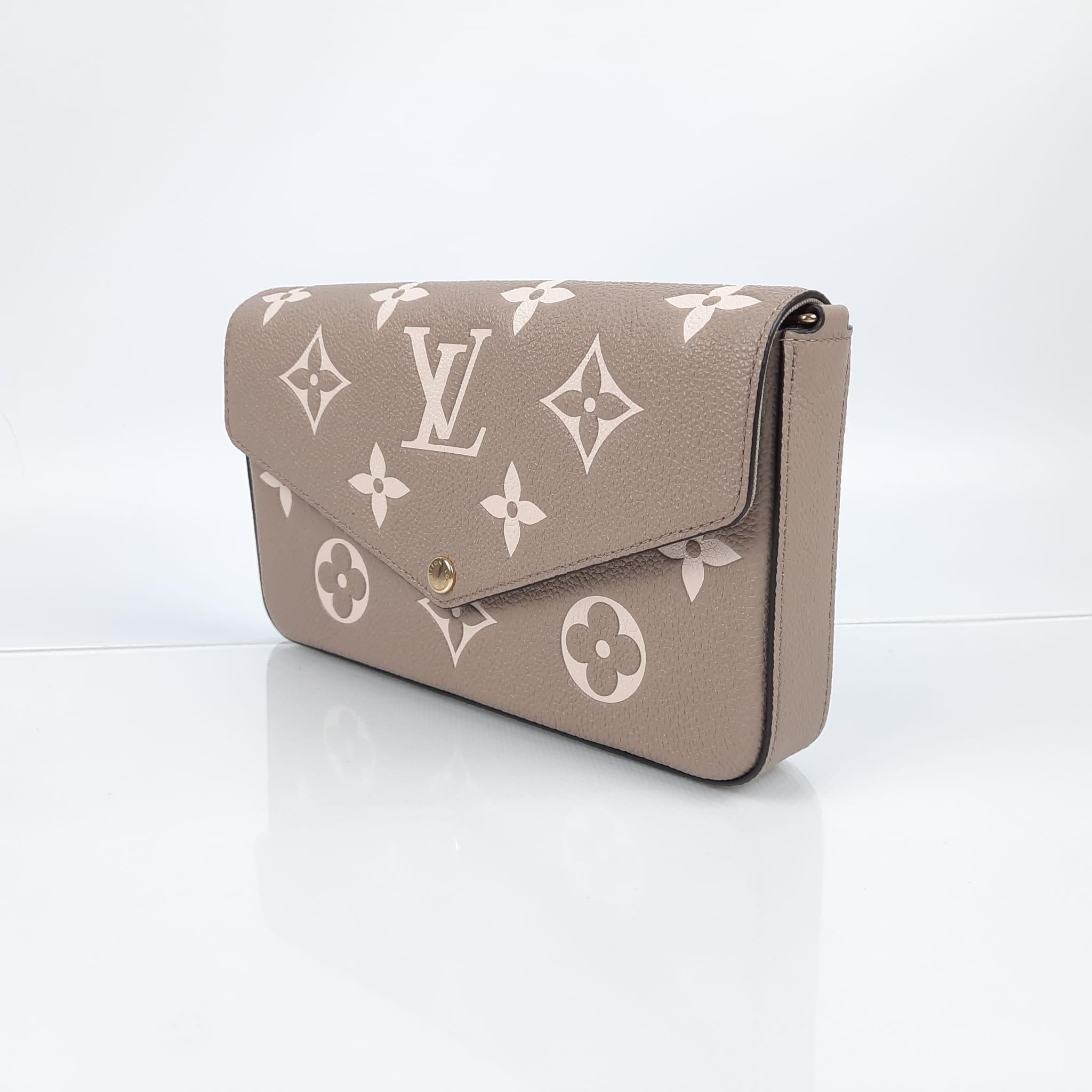 Tourterelle Grey/Cream
Monogram Empreinte embossed supple grained cowhide leather
Textile lining
Gold-colour hardware
Removable metallic chain for shoulder or cross-body carry 
Press stud closure
Large compartment
Inside flat pocket
Removable zipped