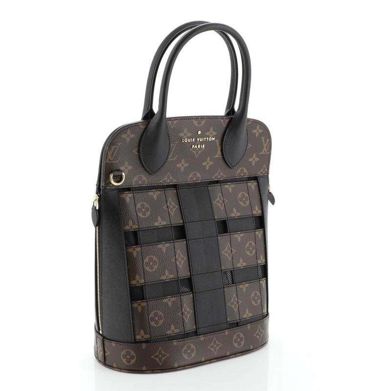 This Louis Vuitton Tressage Tote Monogram MM, crafted in brown monogram coated canvas and black leather, features dual rolled leather handles, leather trim, and gold-tone hardware. It opens to a black fabric interior with zip pocket. Authenticity
