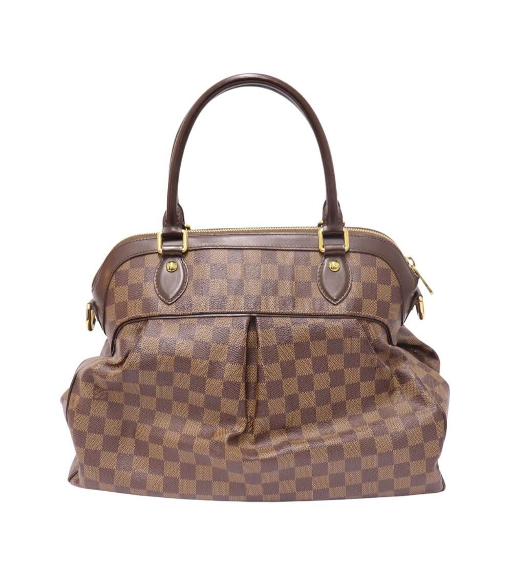 Louis Vuitton Trevi Damier Ebene GM Bag , features a monogrammed canvas, buckle closure, leather handles, studs, and one interior slip pocket.

Material: Leather 
Hardware: Gold
Height: 30cm
Width: 39cm
Depth: 16cm
Handle Drop: 15cm
Overall