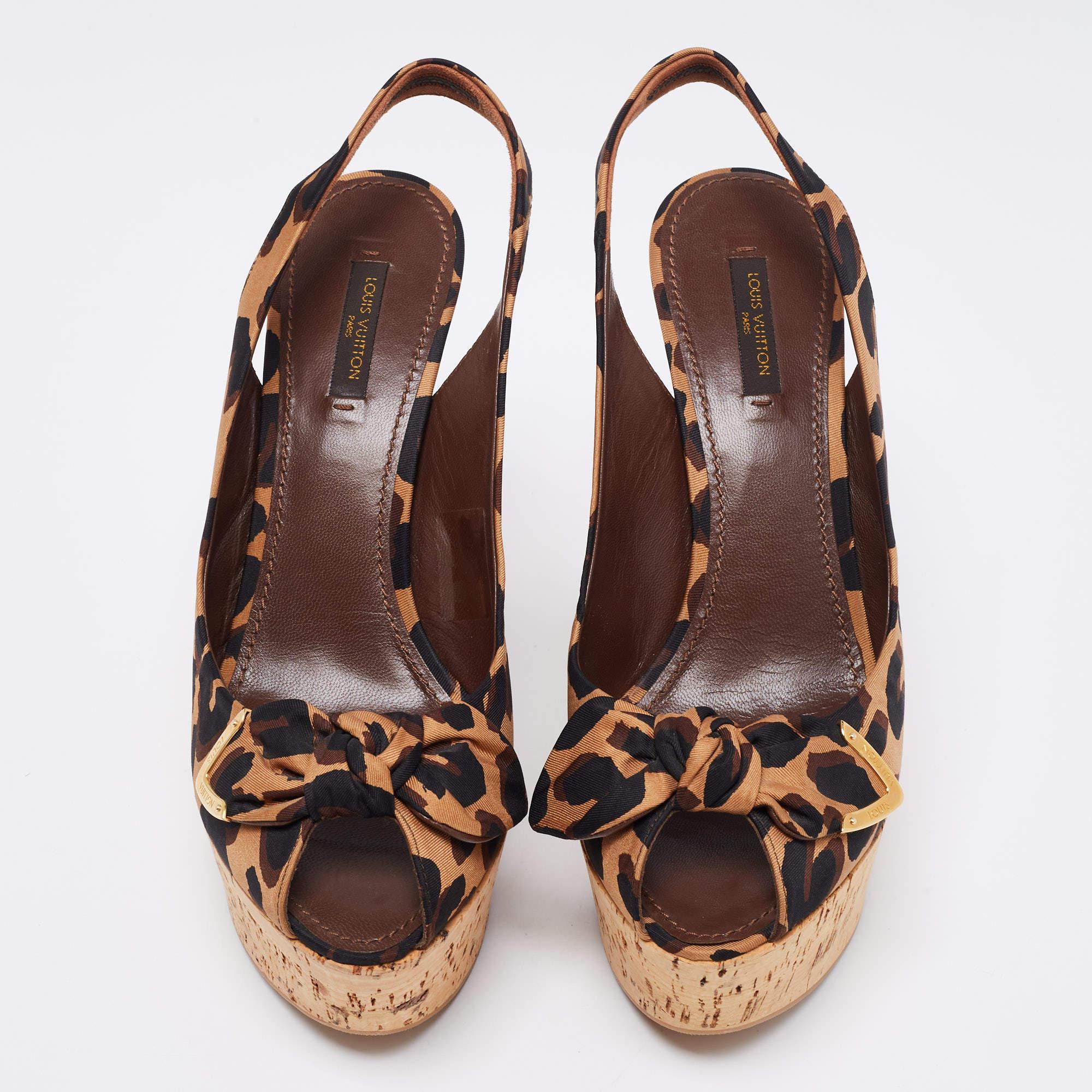 Strut with grace and style as you don these bold sandals by Louis Vuitton. Crafted from leopard-printed canvas, these tricolored beauties have bow detailing on the vamps. They are designed with platforms, slingbacks, and 13 cm wedge heels.

