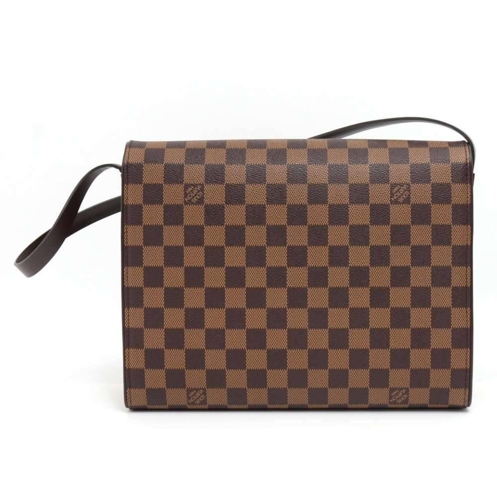 Louis Vuitton Tribeca Long bag in Damier Ebene canvas. It is beautiful design with long flap leather strap. Flap top is secured with magnetic closure. Inside has red lining with 1 open and 1 zipper pocket. Can be carried on the shoulder with the