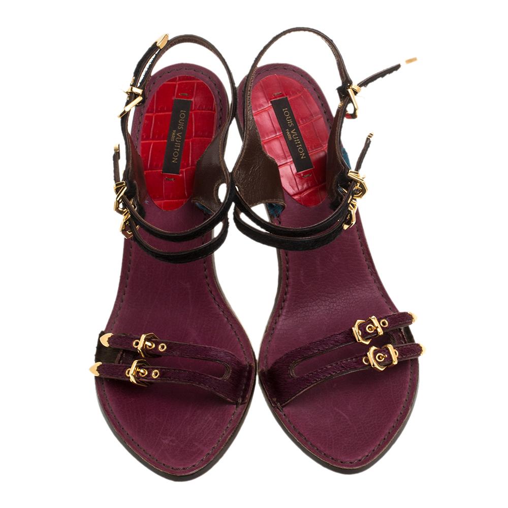 Crafted from luxurious calf hair and croc leather, these stylish and feminine sandals come from Louis Vuitton. They feature open toes and twin buckled straps on the vamps and ankles. The pretty hues add extra style to this lovely pair. The insoles