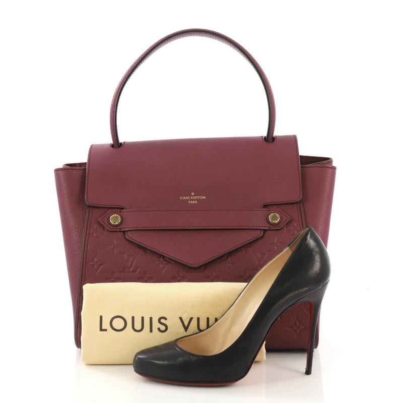 This Louis Vuitton Trocadero Handbag Monogram Empreinte Leather, crafted from purple monogram empreinte leather, features a looping top handle, subtle LV logo at front, protective base studs, and gold-tone hardware. Its hidden magnetic closure opens