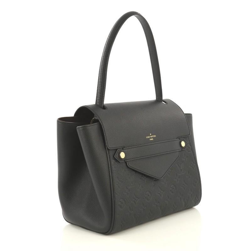 This Louis Vuitton Trocadero Handbag Monogram Empreinte Leather, crafted from black monogram empreinte leather, features a looping top handle, subtle LV logo at front, protective base studs, and gold-tone hardware. Its hidden magnetic closure opens