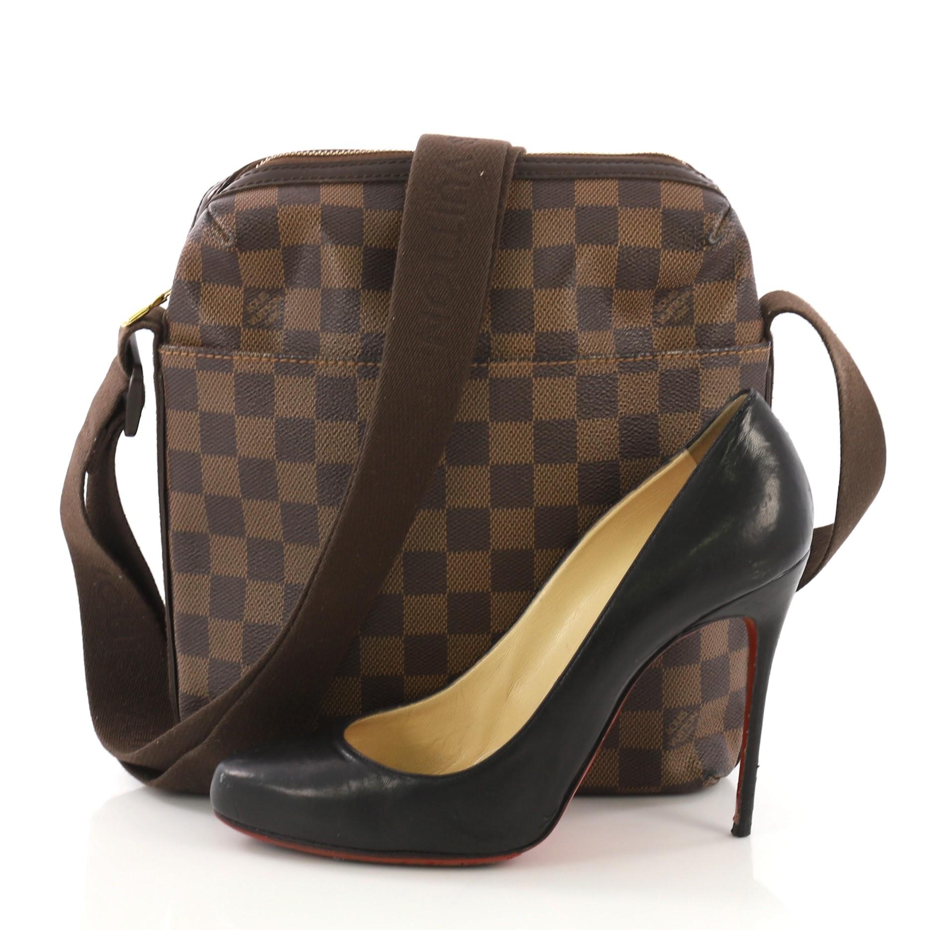 This Louis Vuitton Trotteur Beaubourg Handbag Damier, crafted from damier ebene coated canvas, features an adjustable canvas strap with the Louis Vuitton logo, exterior front slip pocket and gold-tone hardware. Its zip closure opens to a brown