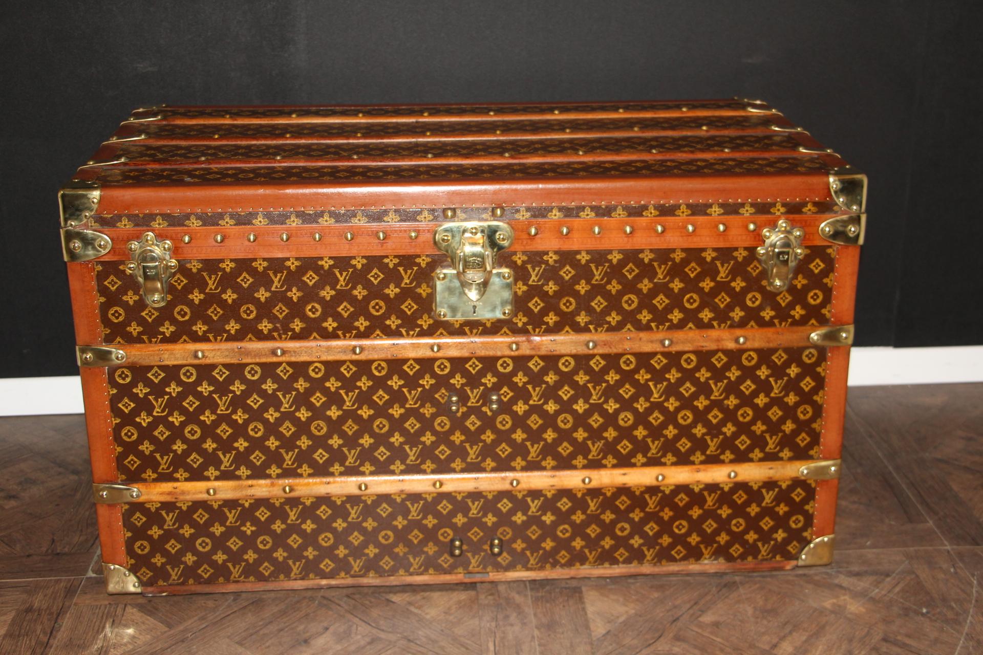 This beautiful Louis Vuitton trunk is all stenciled LV monogram canvas, with all Louis Vuitton stamped solid brass hardware and lozine trim. It features large leather side handles as well as customized painted French flag on each side. It has got a