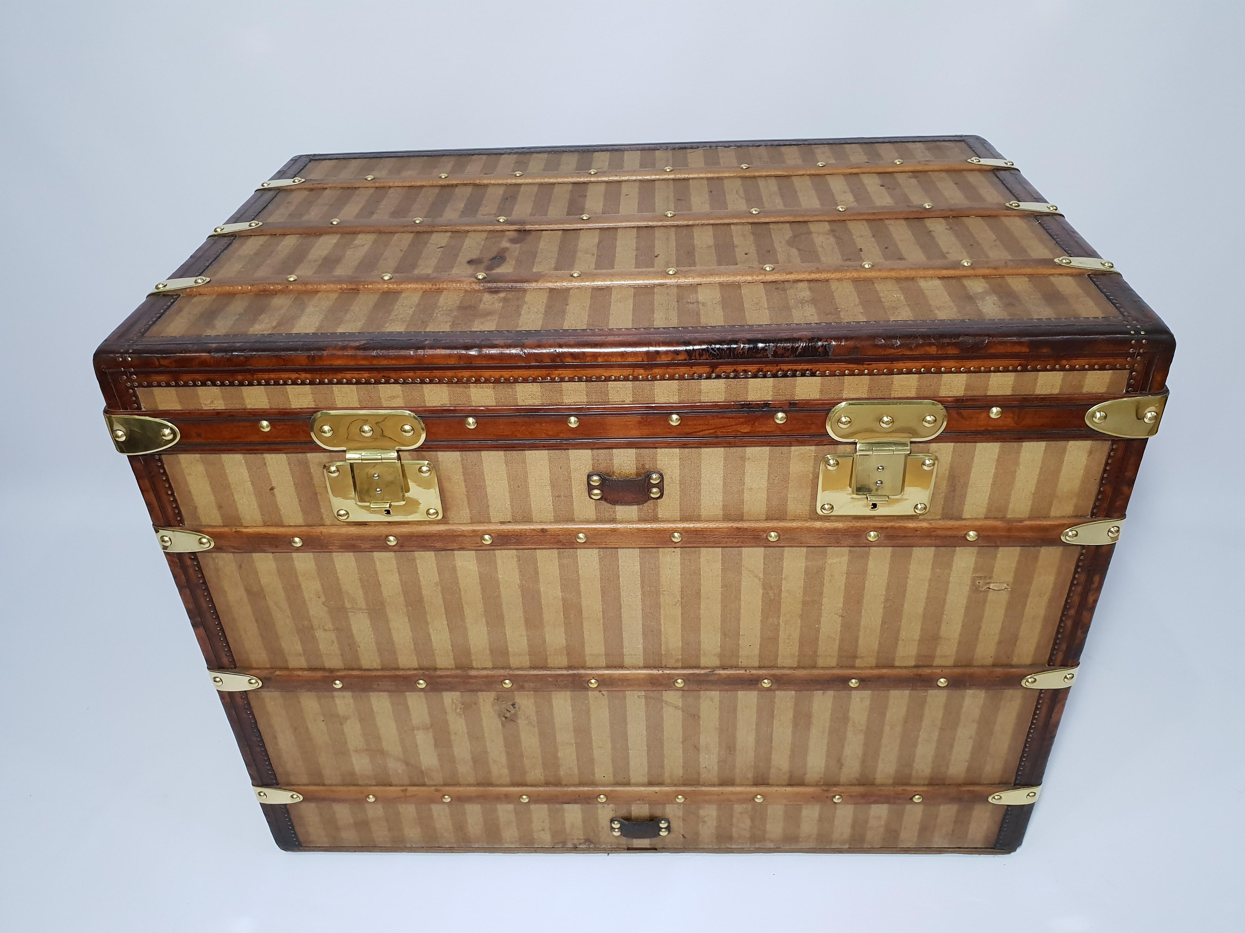 For sale a very rare haut courier Louis Vuitton trunk finished in striped or rayee canvas with leather bounding and brass hardware, very rare purple 100% genuine interior with tricolored French flag ribbon and all interior trays.

An amazing piece