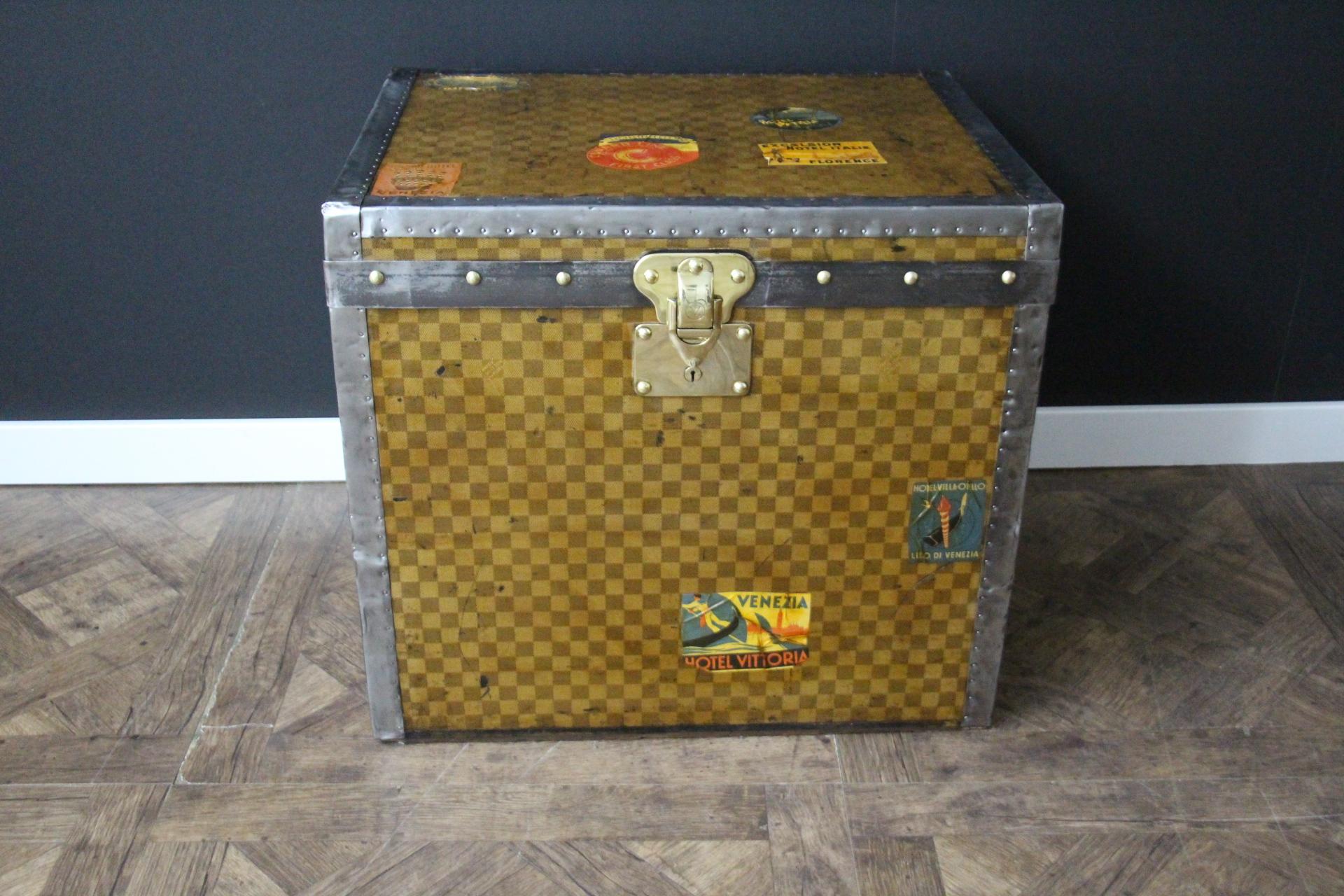 This beautiful Louis Vuitton trunk features the very rare and sought after checkered pattern canvas. This canvas that also called damiers canvas is typical from the end of the 19th century. Moreover, it features silver trim and  hardware: corners,