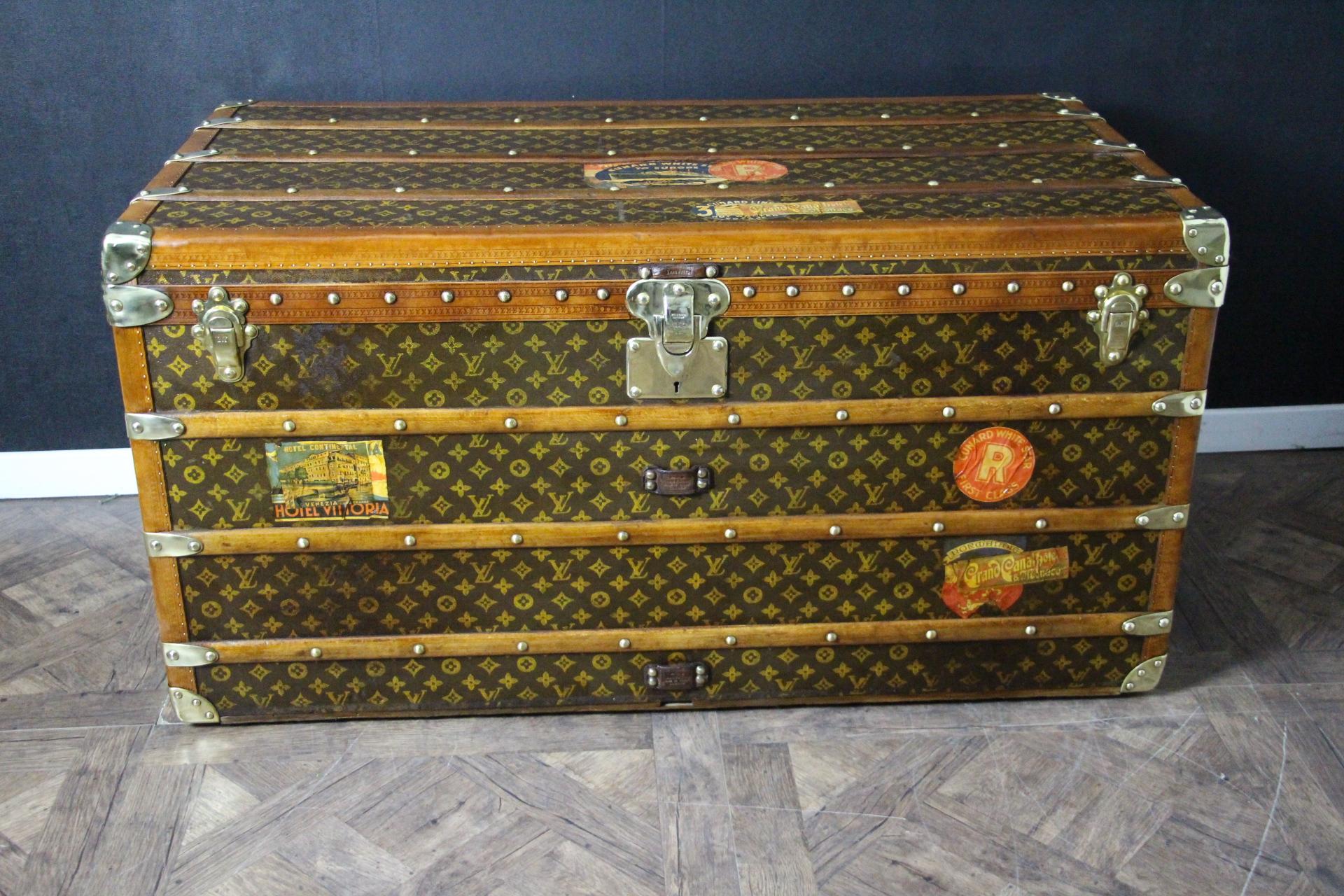 This magnificent Louis Vuitton steamer trunk features stenciled monogram canvas, honey color lozine trim, LV stamped solid brass locks and studs as well as leather side handles and brass corners. It has got a beautiful original patina and is very