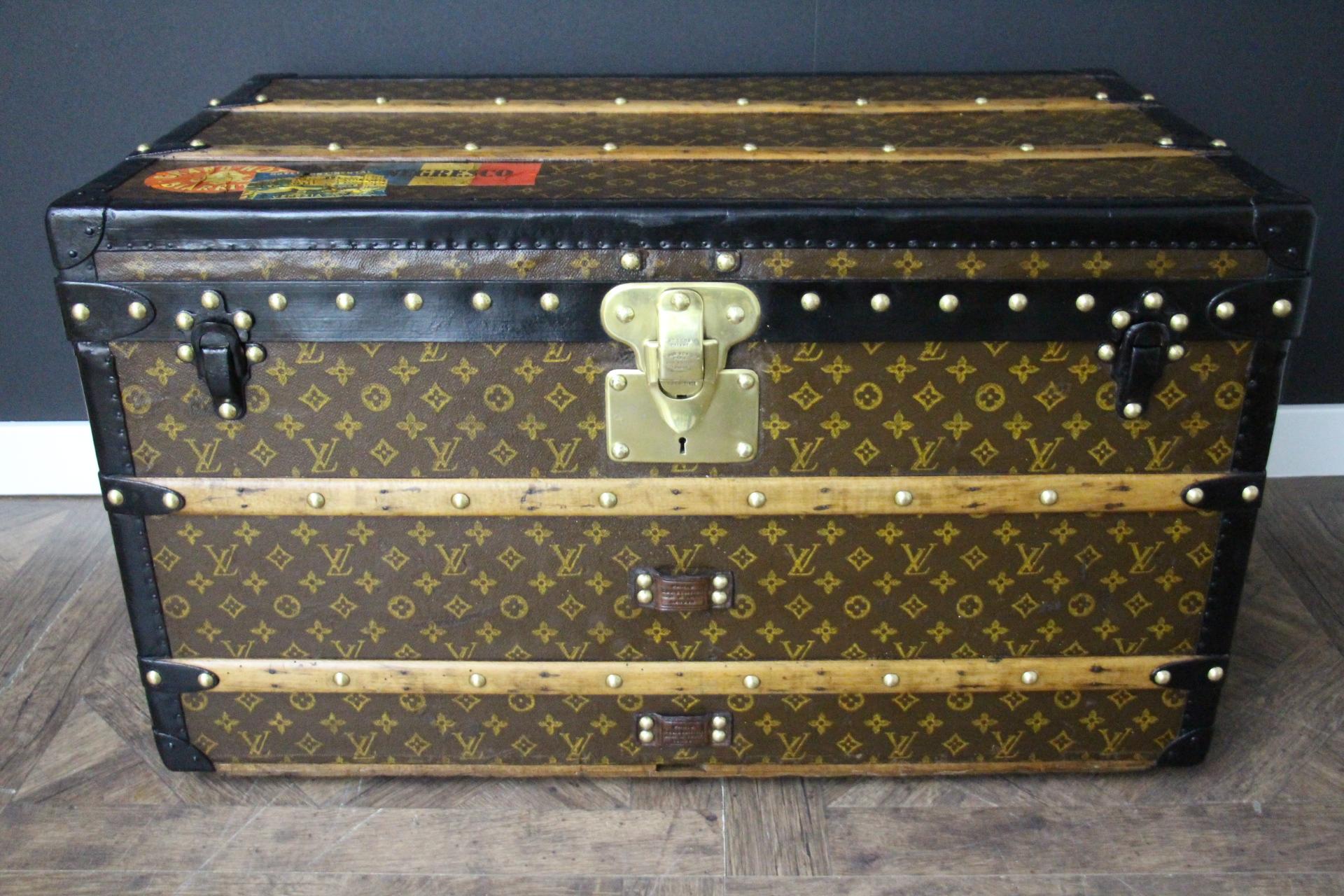 This beautiful Louis Vuitton trunk dates to around 1920. It features stenciled monogram canvas, black lozine and leather trims, black steel clasps, solid brass main lock and steel side handles.
Every single brass stud is stamped Louis Vuitton, as