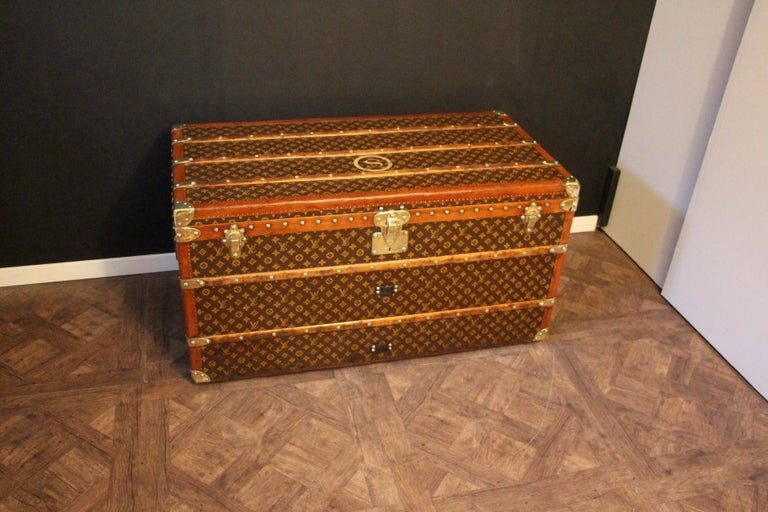 This beautiful Louis Vuitton trunk is all stenciled LV monogram canvas, with all Louis Vuitton stamped solid brass hardware and lozine trim. It features large leather side handles as well as customized painted French flag on each side. It has got a
