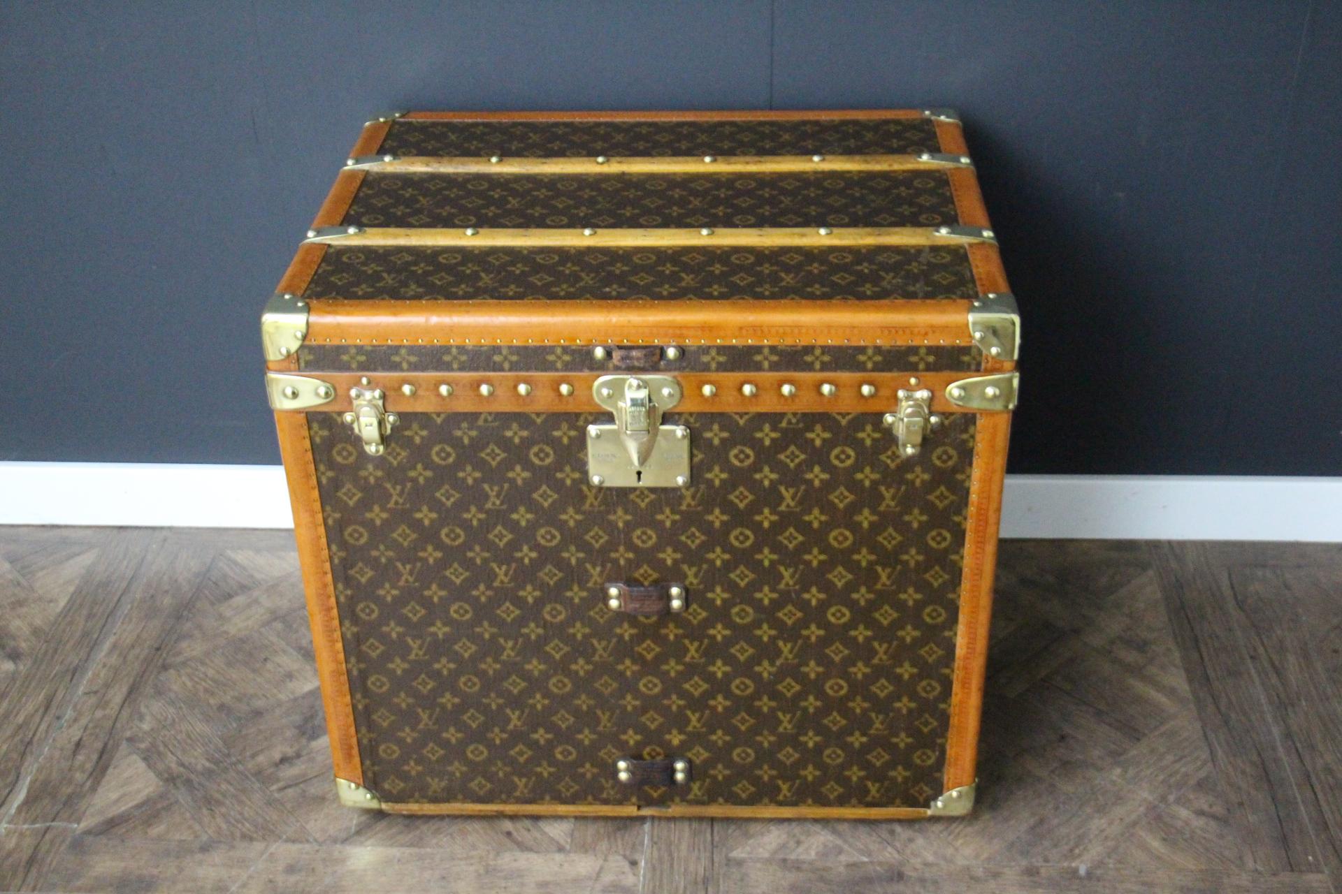 This beautiful and very rare Louis Vuitton trunk features hand painted stenciled monogram canvas, honey color lozine trim, large leather side handles, stamped Louis Vuitton brass studs, lock and clasps. Its patina is magnificent. Moreover it has a