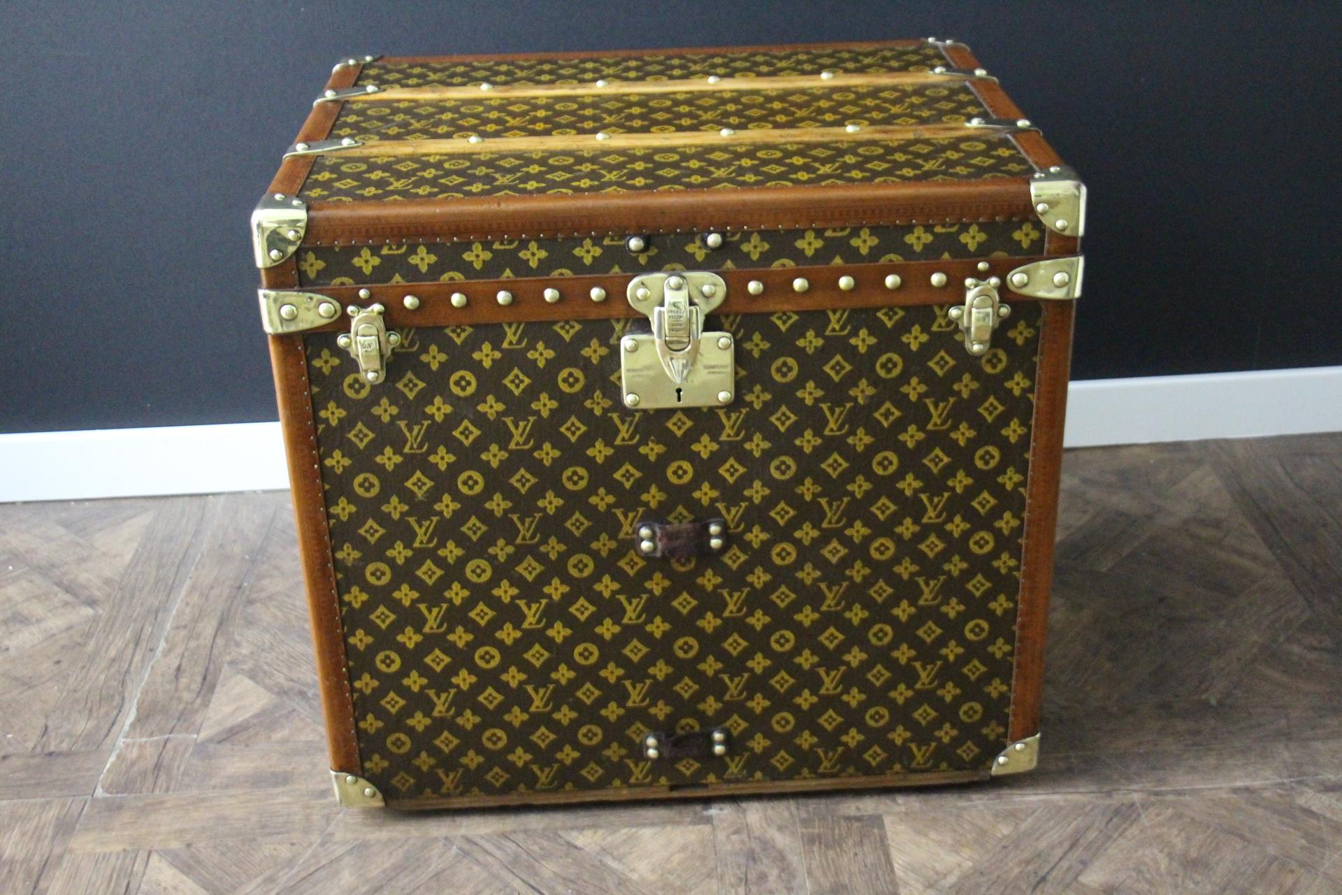 This beautiful and very rare Louis Vuitton trunk features hand painted stenciled monogram canvas, honey color lozine trim, large leather side handles, stamped Louis Vuitton brass studs, lock and clasps. It also features hand painted turquoise blue