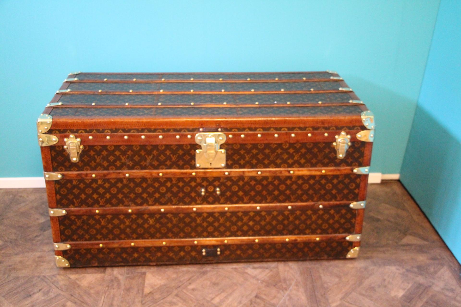 Magnificent Louis Vuitton steamer trunk featuring stenciled monogram canvas, honey color trim, stamped LV solid brass lock and clasps, brass corners and stamped LV studs. It has got a beautiful and warm patina. Leather side handles.

Original and