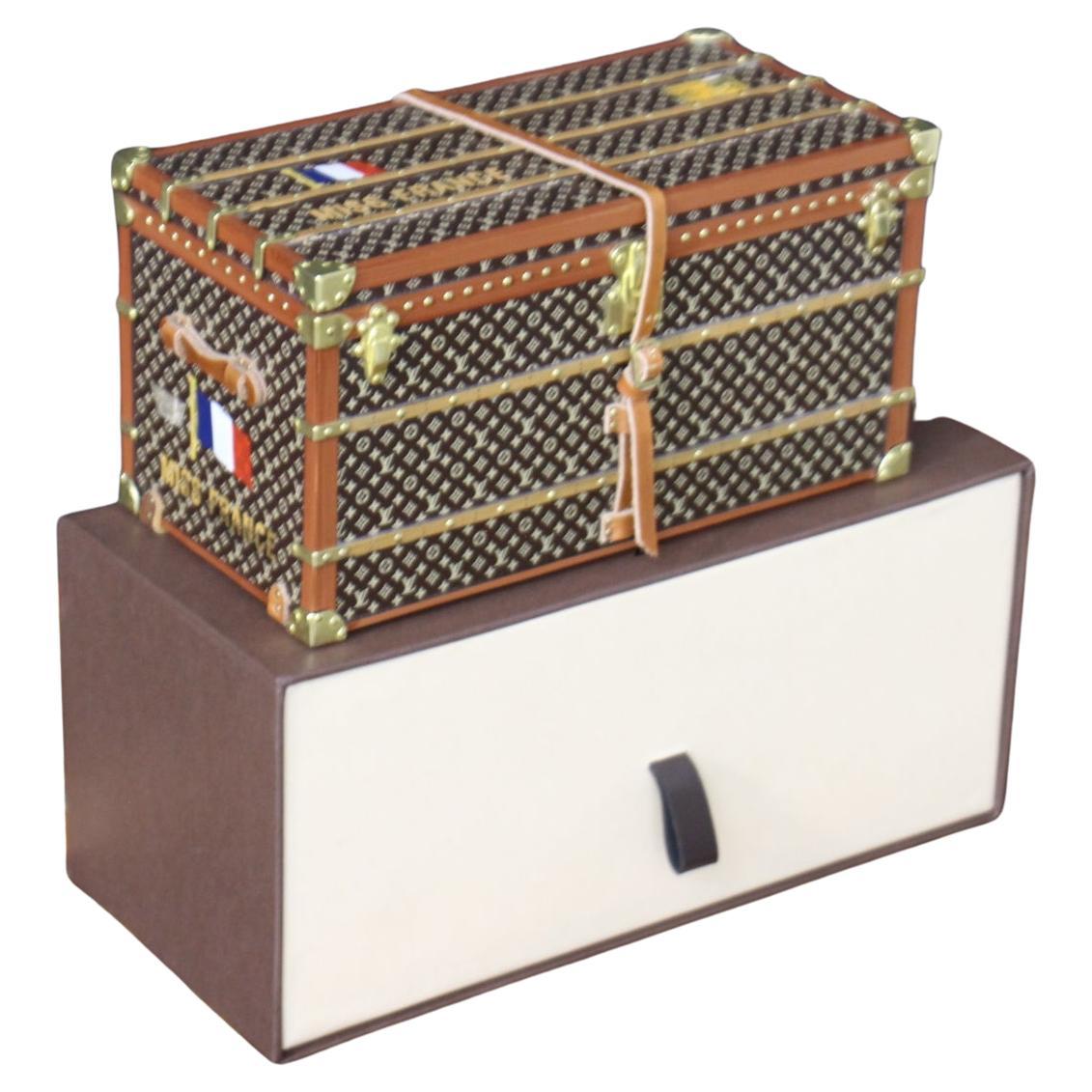 This magnificent mini Louis Vuitton trunk is a very special, rare, and unique paperweight . It used to be a gift that Louis Vuitton offered to its VIP clients, and Louis Vuitton never sold it. This is the exact  reproduction of the Louis Vuitton