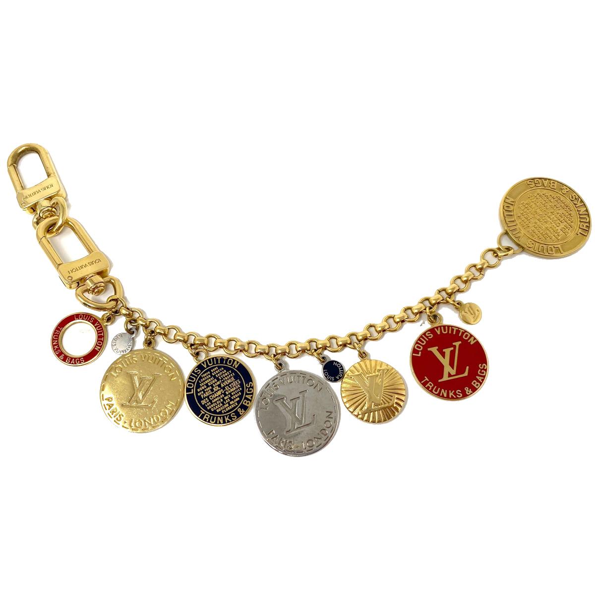 Company-Louis Vuitton 
Style-Trunks and Bags Multicolor Chain Bag Charm   
Charms-Charms all have wear consistent with age and use 
Hooks -two clip on clasps on bag charm
Charm Colors-2 red charms , 3 Gold Charms , 2 blue 
Handles/