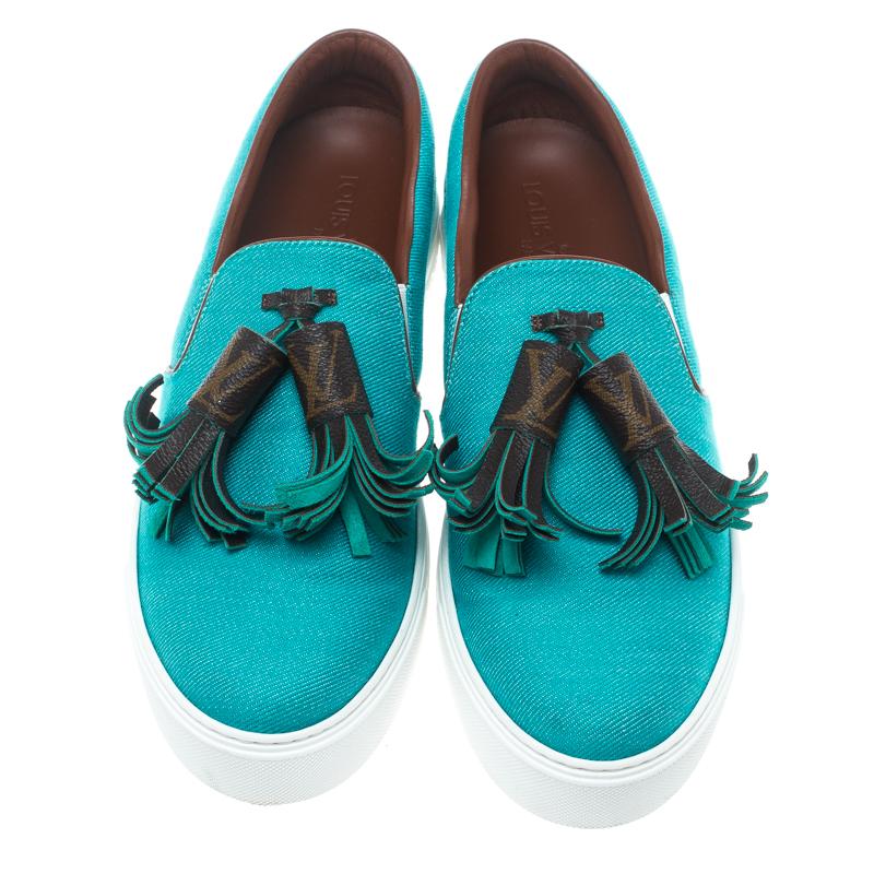 Flaunt your high-style with these trendy sneakers from Louis Vuitton! They've been carefully crafted from turquoise twill fabric, and designed with monogram tassels on the uppers and the LV logo on the midsoles. You are sure to receive both comfort