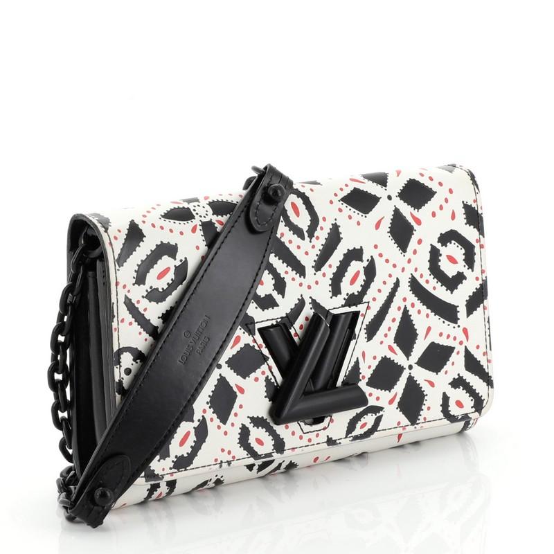 This Louis Vuitton Twist Chain Wallet Limited Edition Graphic Leather, crafted in white leather with multicolor graphic prints, features chain strap with leather pad and black-tone hardware. Its LV twist lock closure opens to a black leather