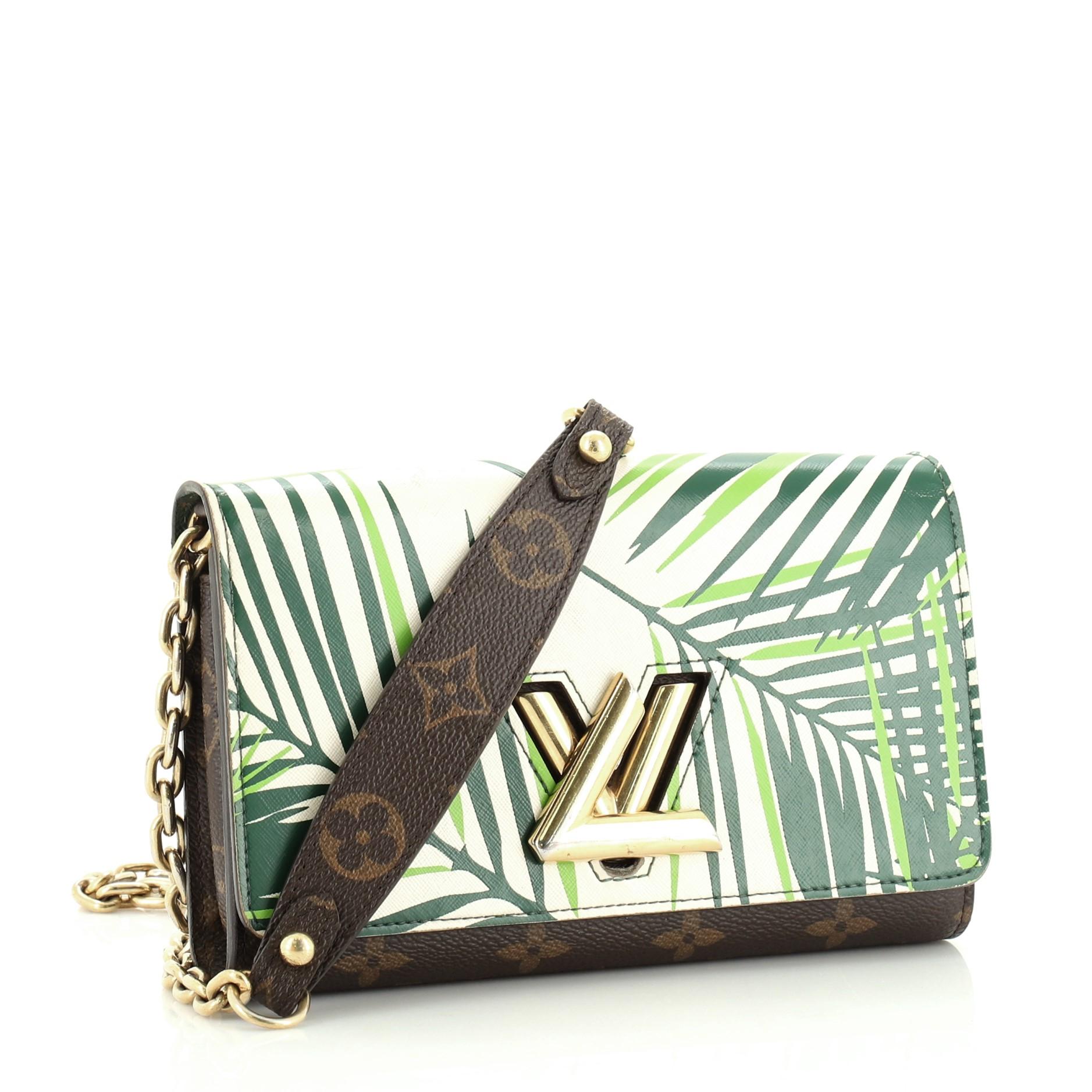 This Louis Vuitton Twist Chain Wallet Limited Edition Palm Print Leather with Monogram Canvas, crafted in green printed leather with brown monogram coated canvas, features chain strap with leather pad and gold-tone hardware. Its LV twist lock