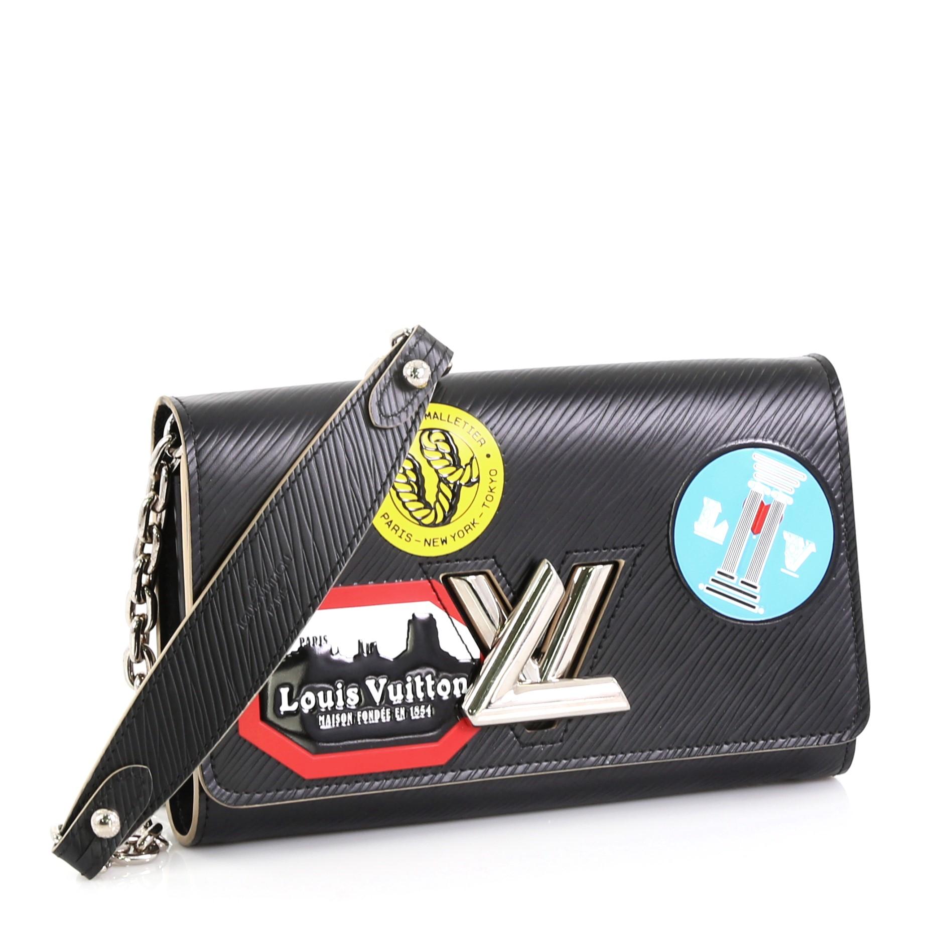 This Louis Vuitton Twist Chain Wallet Limited Edition World Tour Epi Leather, crafted in black epi leather, features LV twist lock, shoulder chain strap, and silver-tone hardware. Its flap opens to a black leather interior with multiple card slots,